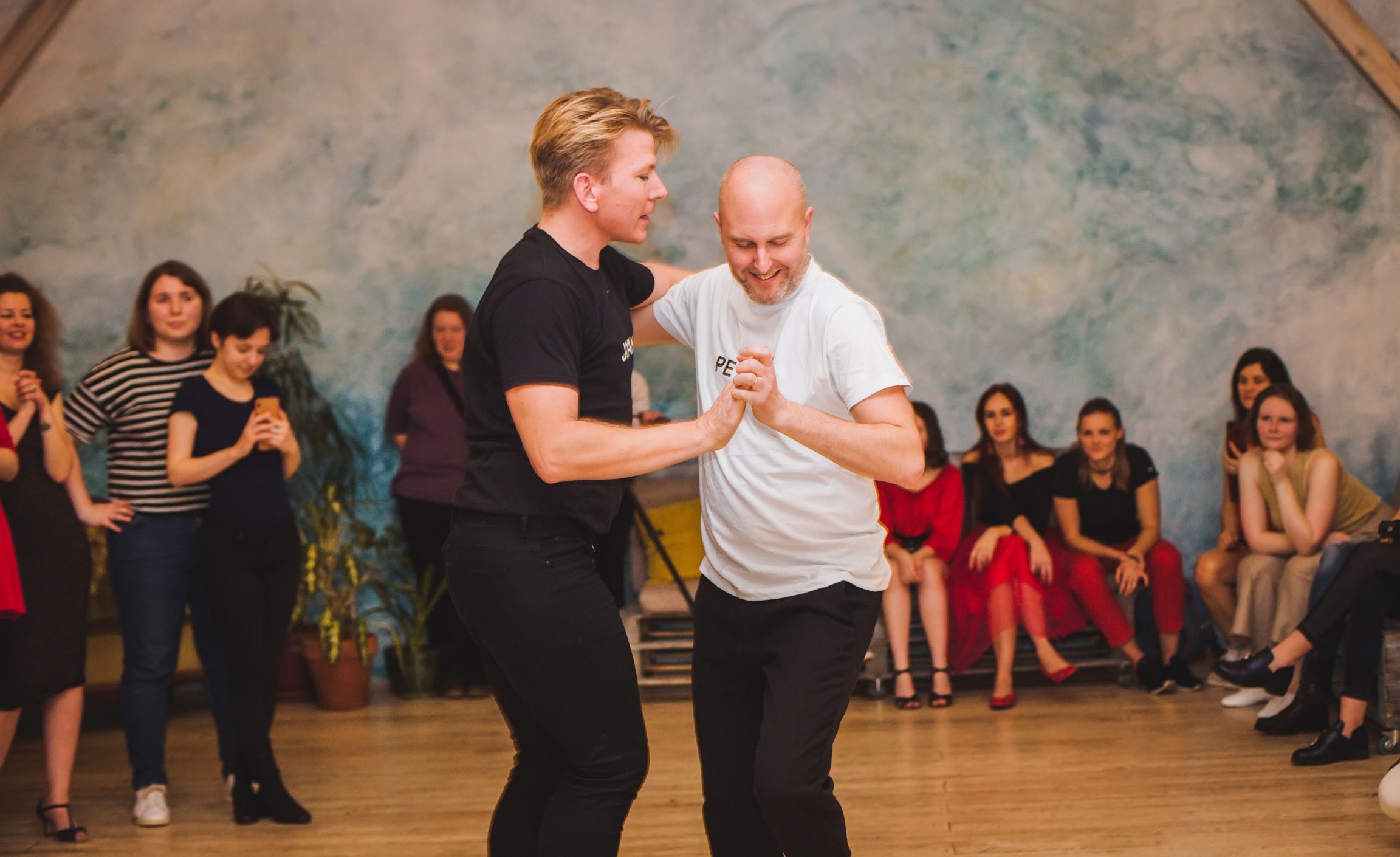 Swedish queer salsa instructors Johan Bjoerk and Peter Helm (left to right) who taught at the festival. A salsa instructor dances with a student.