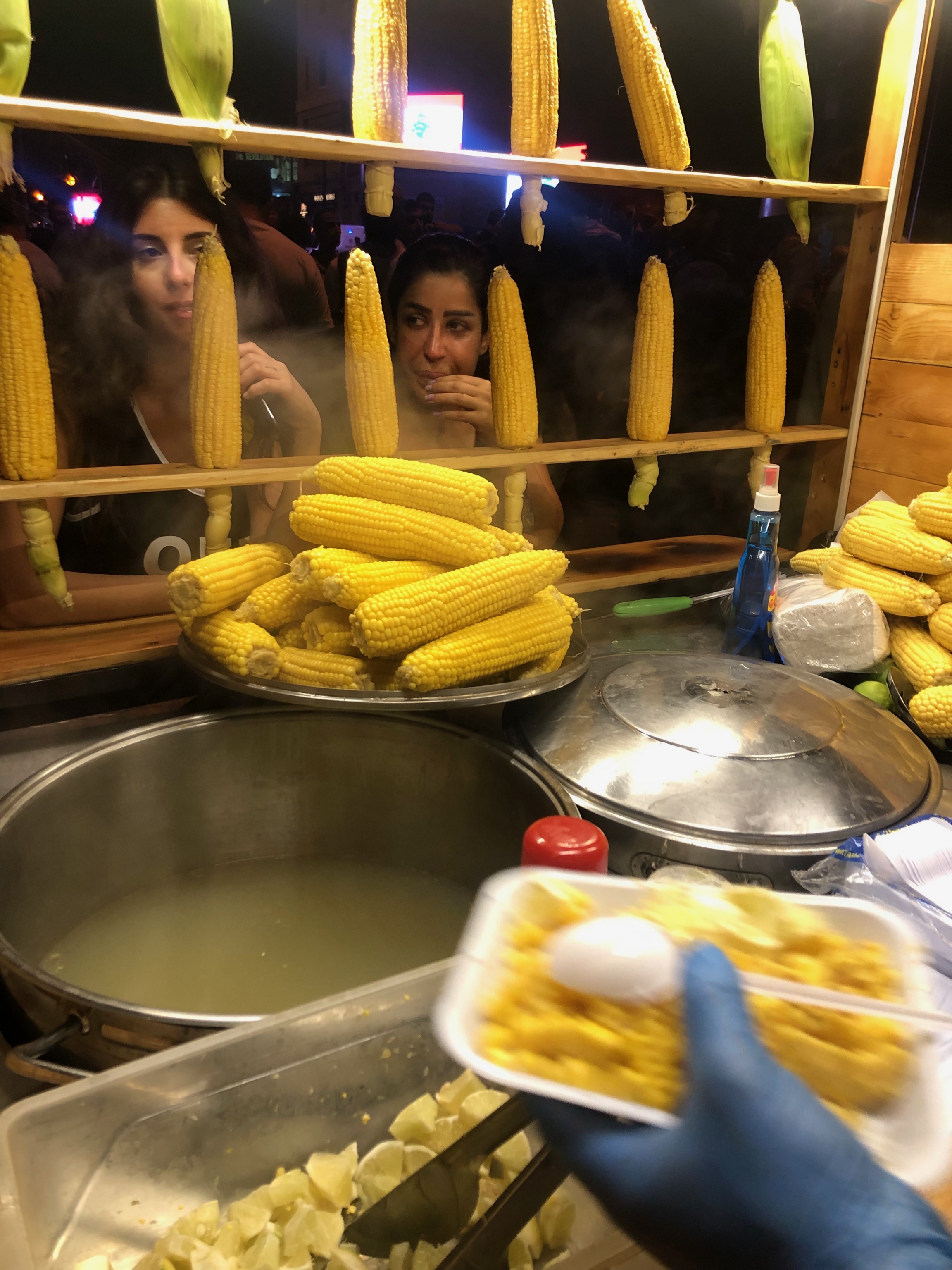 Protesters buy corn from a vendor on Beirut's Ring bridge during a road closure. Protesters buy corn from a vendor on Beirut's Ring bridge during a road closure.