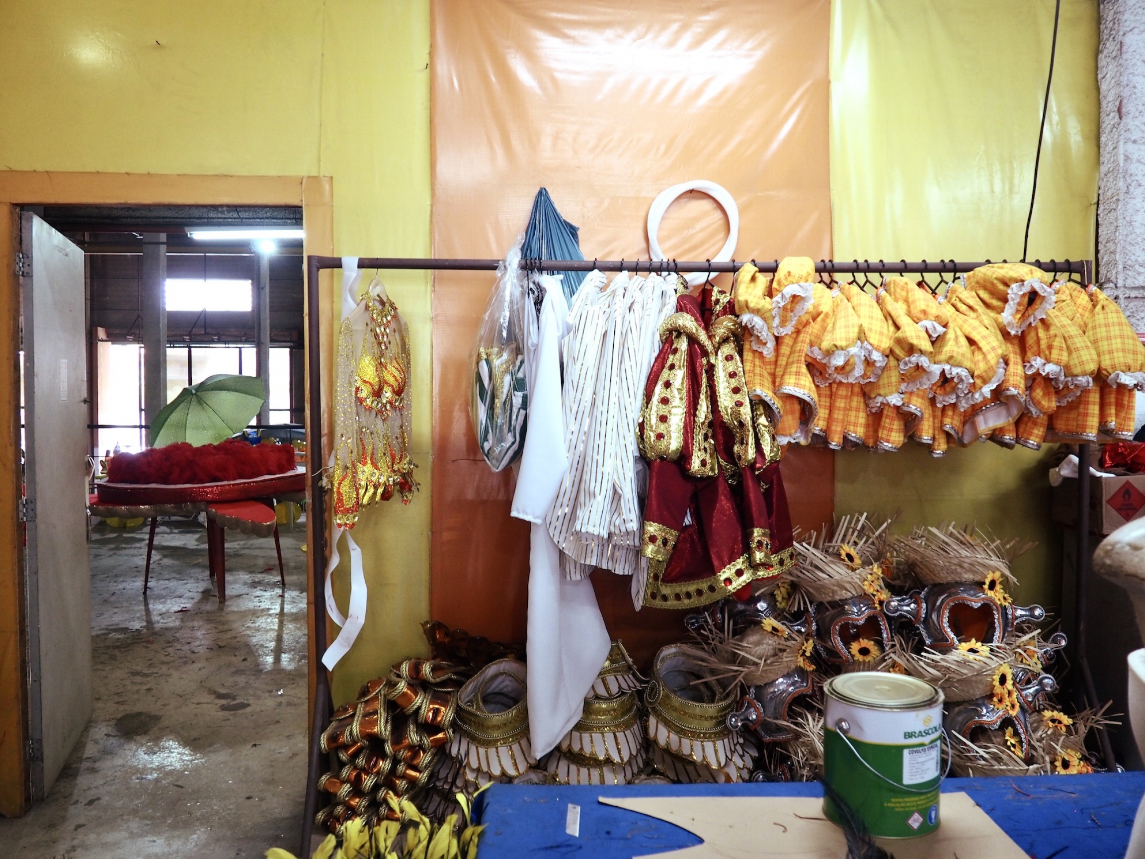 Just-completed dance costumes await carnival in the São Clemente samba school's workshop. parade preparation