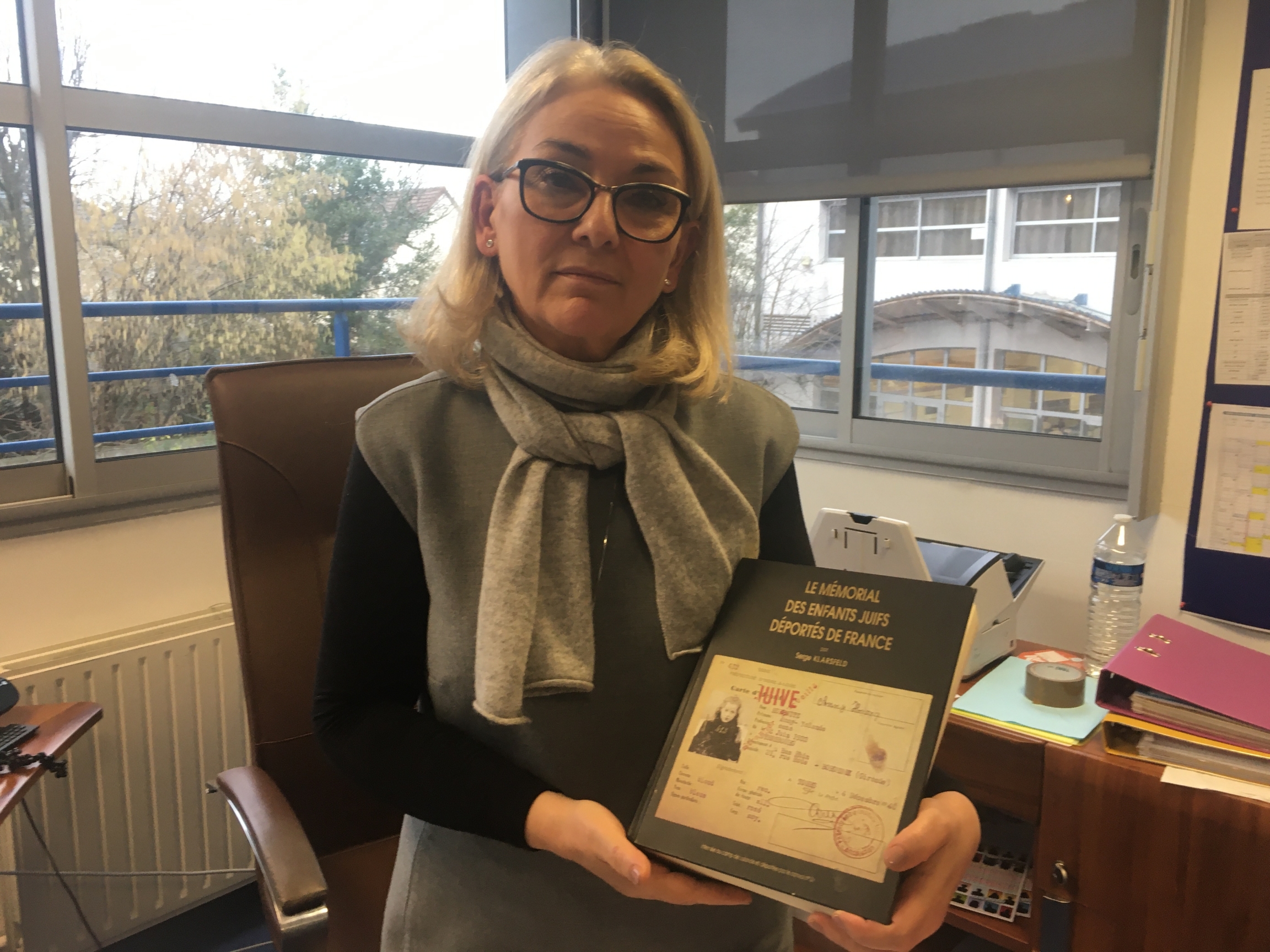 Sarah-Laure Attias, the director of a private Jewish school on the outskirts of Paris, holds a book listing the names of every Jewish child deported from France during World War II. Attias says students at her school need to be extra prepared when it come Sarah-Laure Attias, the director of a private Jewish school on the outskirts of Paris, holds a book listing the names of every Jewish child deported from France during World War II. Attias says students at her school need to be extra prepared when it come