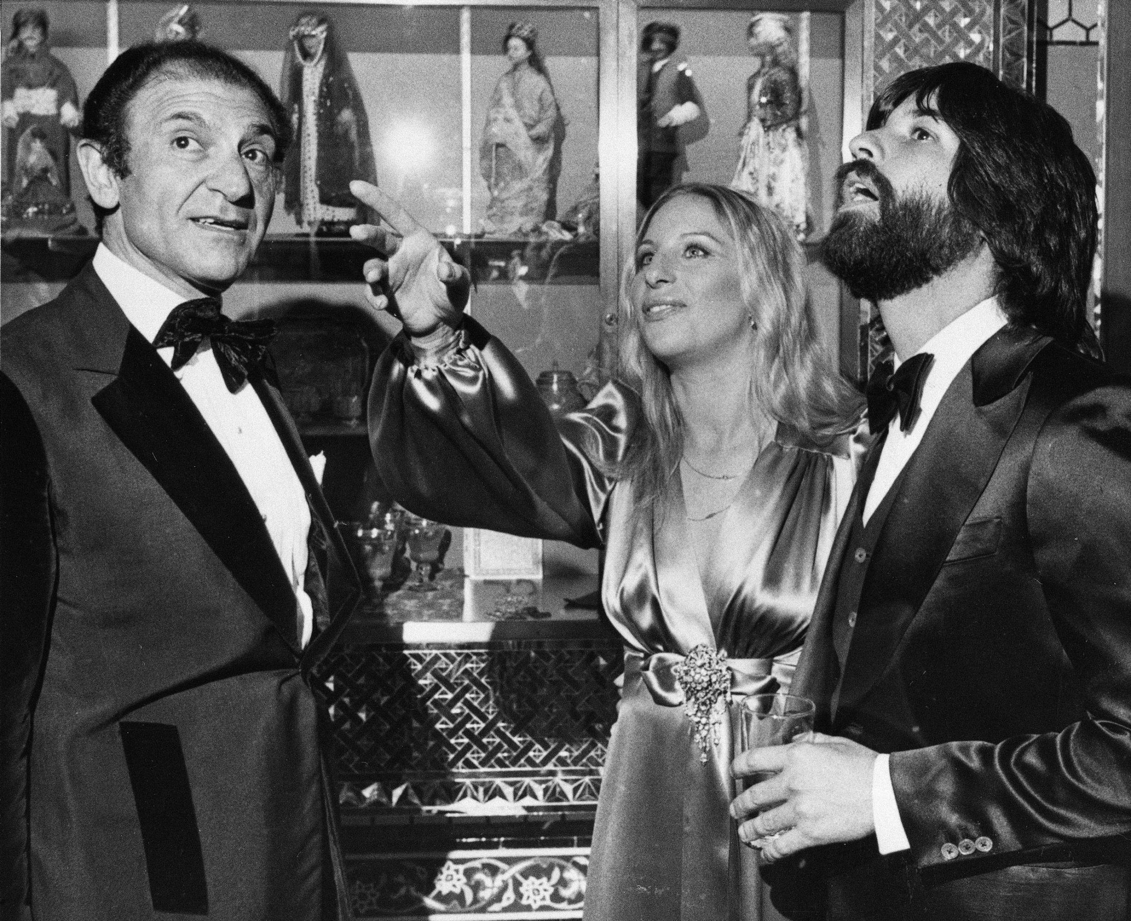 Iran's former Ambassador Ardeshir Zahedi, left, talks with actress Barbra Streisand and her escort Jon Peters as they admire the Iranian Embassy, March 8, 1975 during a reception in Washington DC. Iran's former Ambassador Ardeshir Zahedi, left, talks with actress Barbra Streisand is shown looking up and pointing.