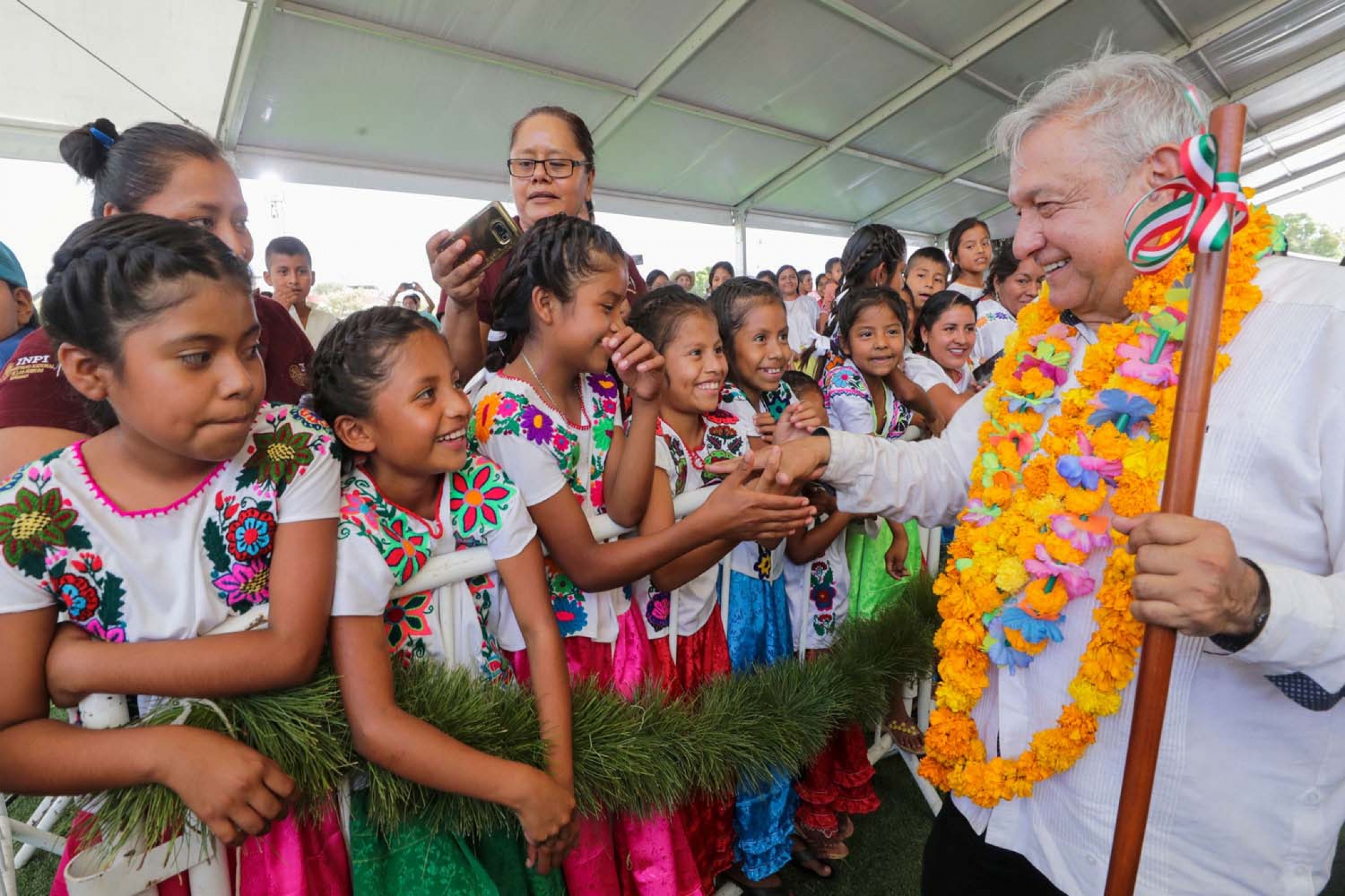 Mexico's President Andrés Manuel López Obrador shakes hands with girls while visiting towns in the southwestern state of Guerrero, as Mexico's health ministry urged people to maintain a "healthy distance" to avoid infection and spread of coronavirus. Mexico's President Andres Manuel Lopez Obrador shakes hands with girls while visiting towns in the southwestern state of Guerrero, as Mexico's health ministry urged people to mantain a "healthy distance" to avoid infection and spread of coronavirus.