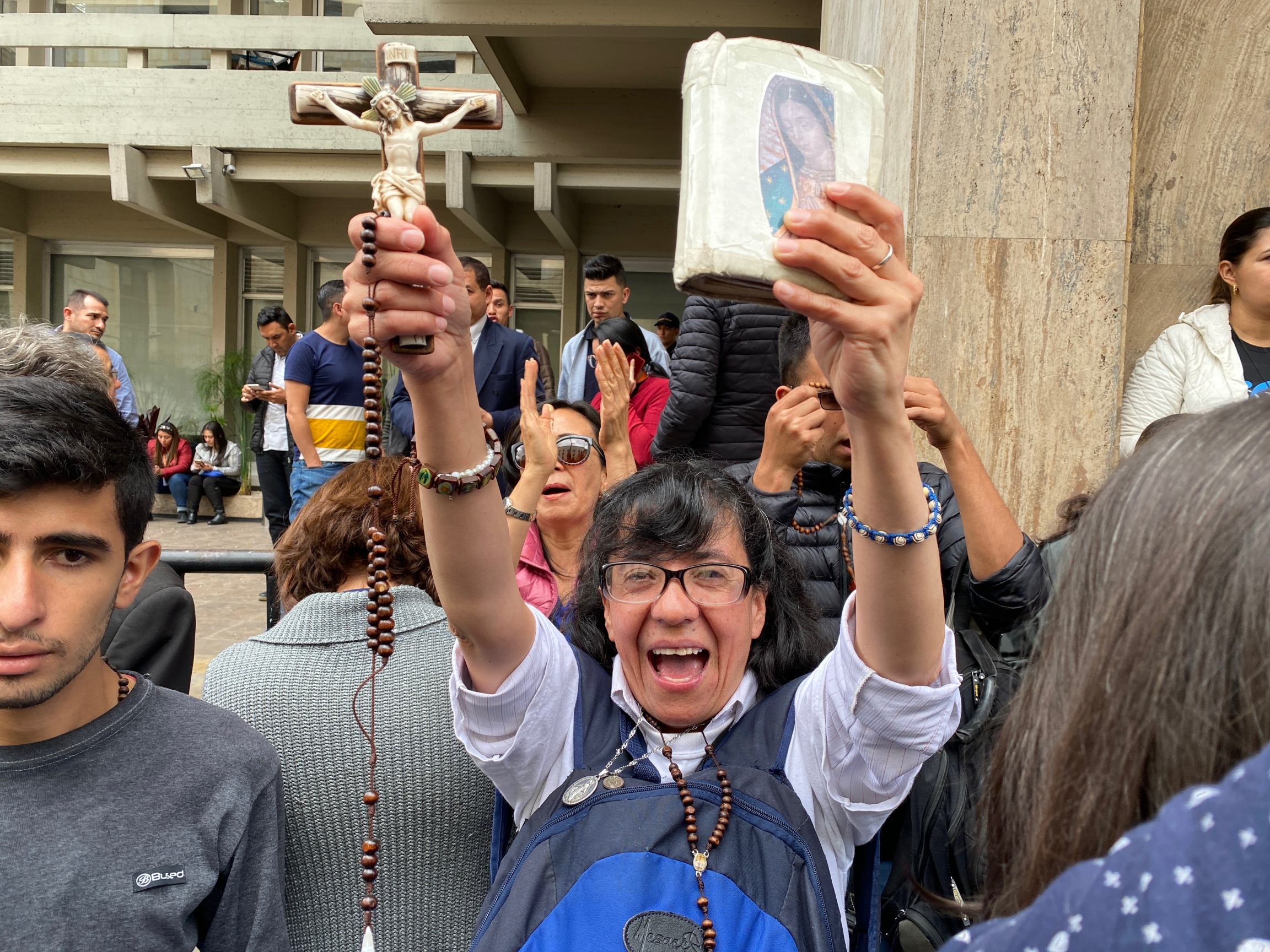 A demonstrator displays her bible and crucifix during a protest outside Colombia's constitutional court. A demonstrator displays her bible and crucifix during a protest outside Colombia's constitutional court.