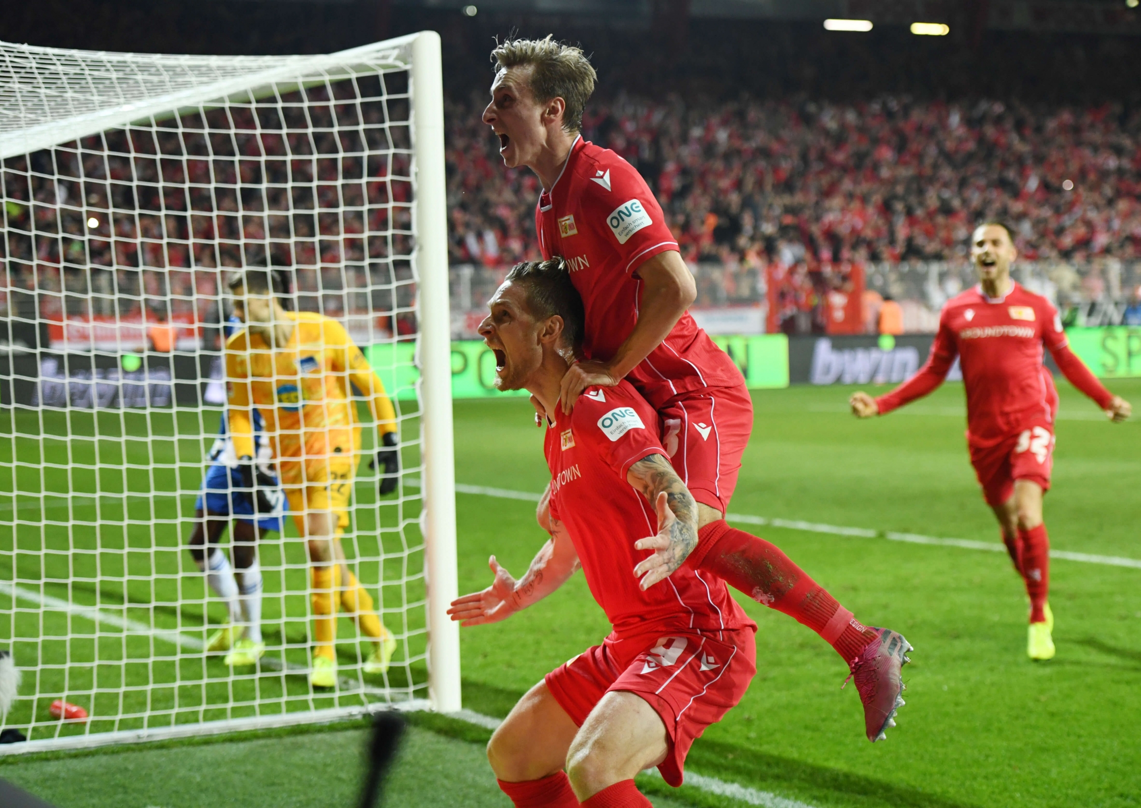 1. FC Union Berlin's Sebastian Polter celebrates scoring their first goal with teammates, Nov. 2, 2019, Berlin, Germany. 1. FC Union Berlin's Sebastian Polter celebrates scoring their first goal with teammates, Nov. 2, 2019, Berlin, Germany.