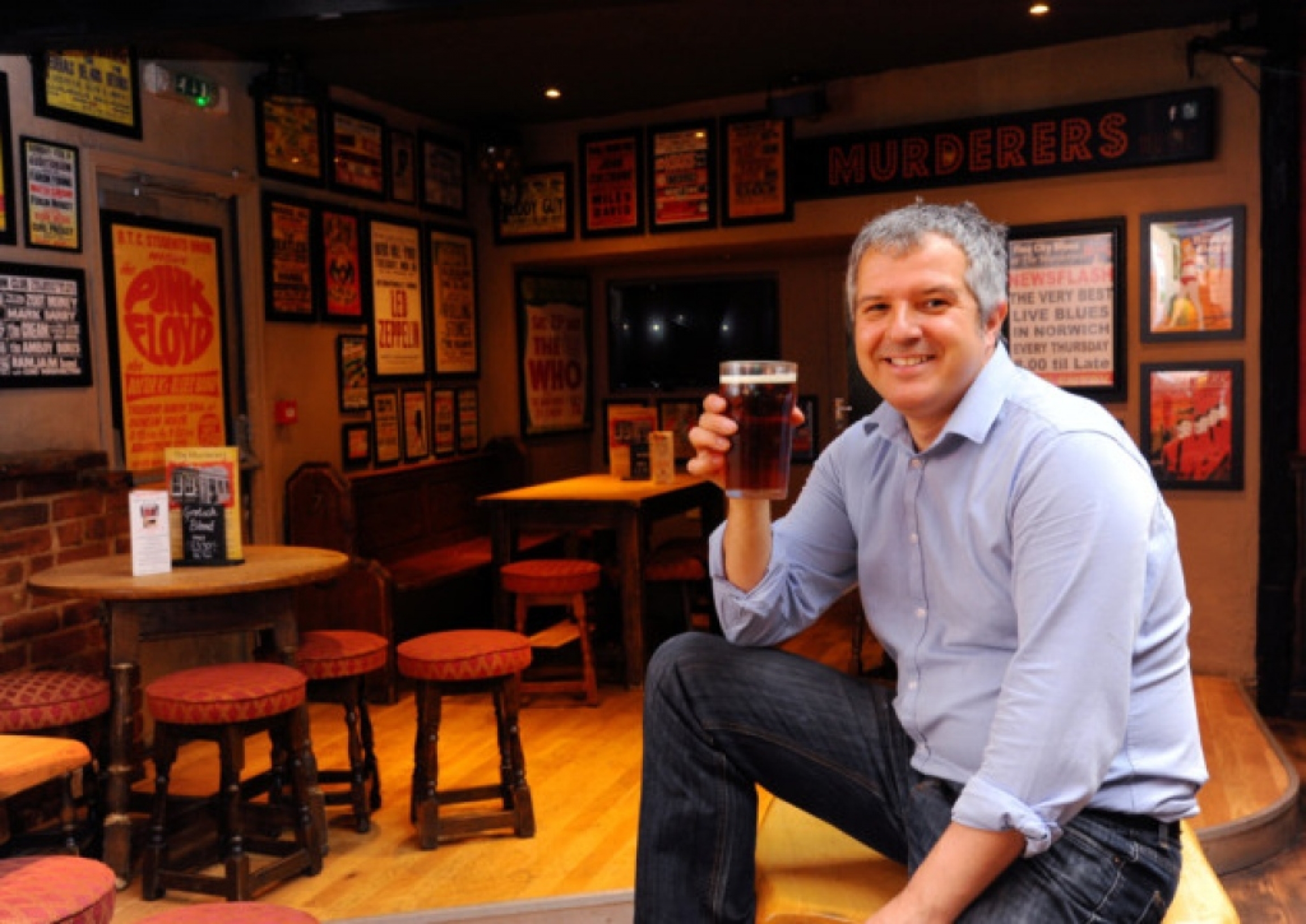 Phillip Cutter drinks a beer at his pub. A man enjoys a beer in a pub