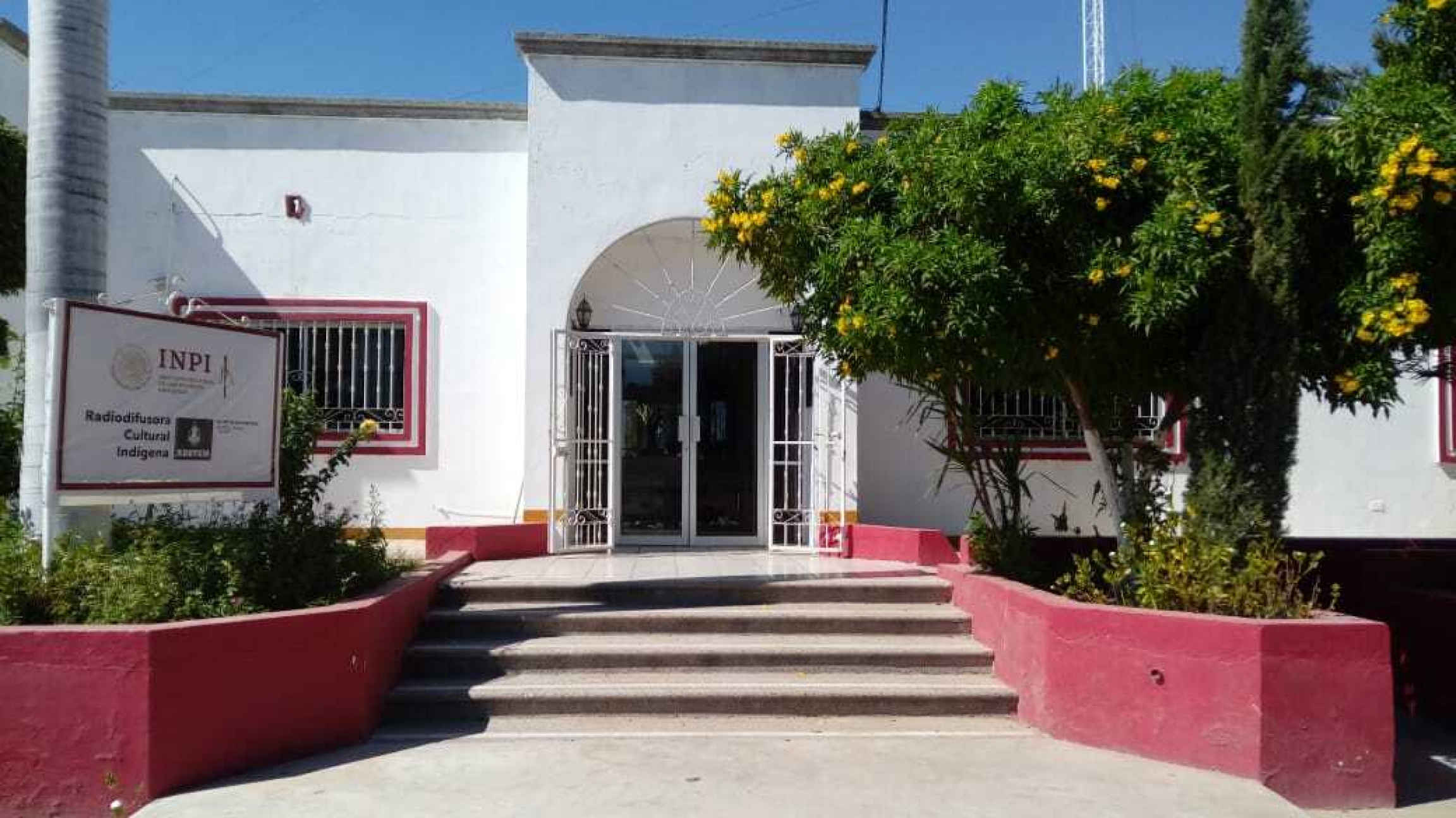 La Voz de los Tres Rios radio station, Etchojoa, Sonora state, Mexico. A white building with sign.