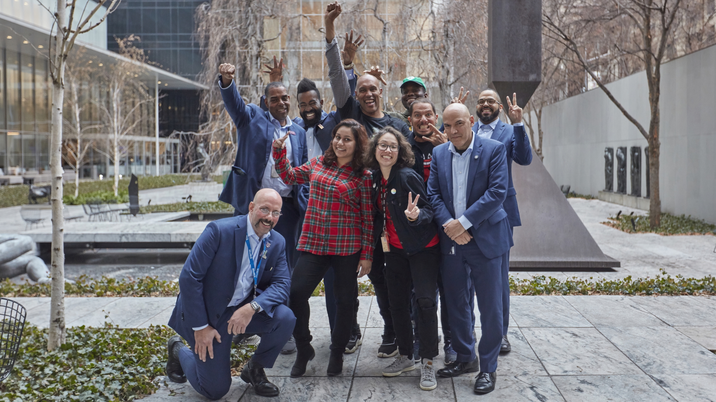 A group of MoMA security guards pose with artist Chemi Rosado-Seijo, far right, creator of an audio guard where the guards explain their favorite works of art. A group of MoMA security guards pose with artist Chemi Rosado-Seijo, far right, creator of an audio guard where the guards explain their favorite works of art.