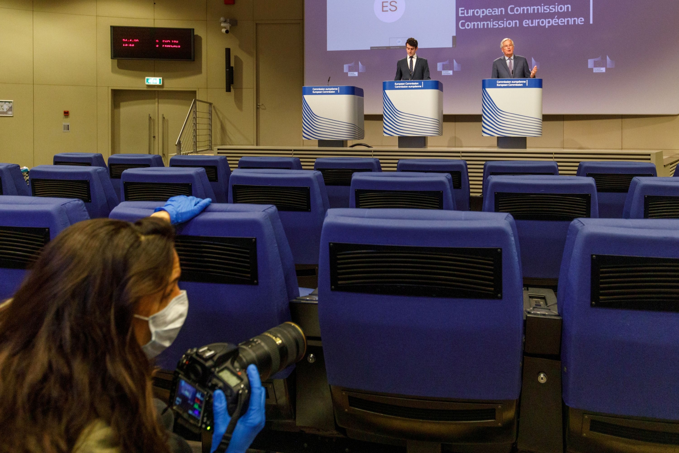 EU's Brexit negotiator Michel Barnier gives a news conference after Brexit negotiations, in Brussels, Belgium, on April 24, 2020. EU's Brexit negotiator Michel Barnier gives a news conference after Brexit negotiations, as a photographer wearing a mass passes by in the foreground, in Brussels, Belgium, on April 24, 2020.