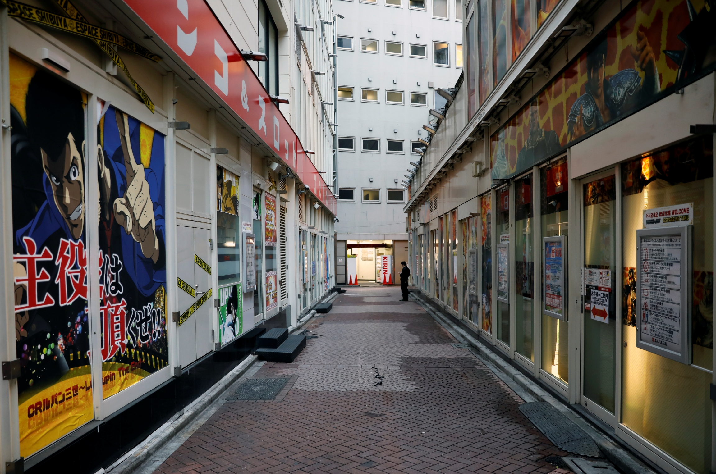 A man stands in front of a closed Pachinko parlour, following the coronavirus disease (COVID-19) outbreak, in Tokyo, April 28, 2020. A man stands in front of a closed Pachinko parlour, following the coronavirus disease (COVID-19) outbreak, in Tokyo, April 28, 2020.