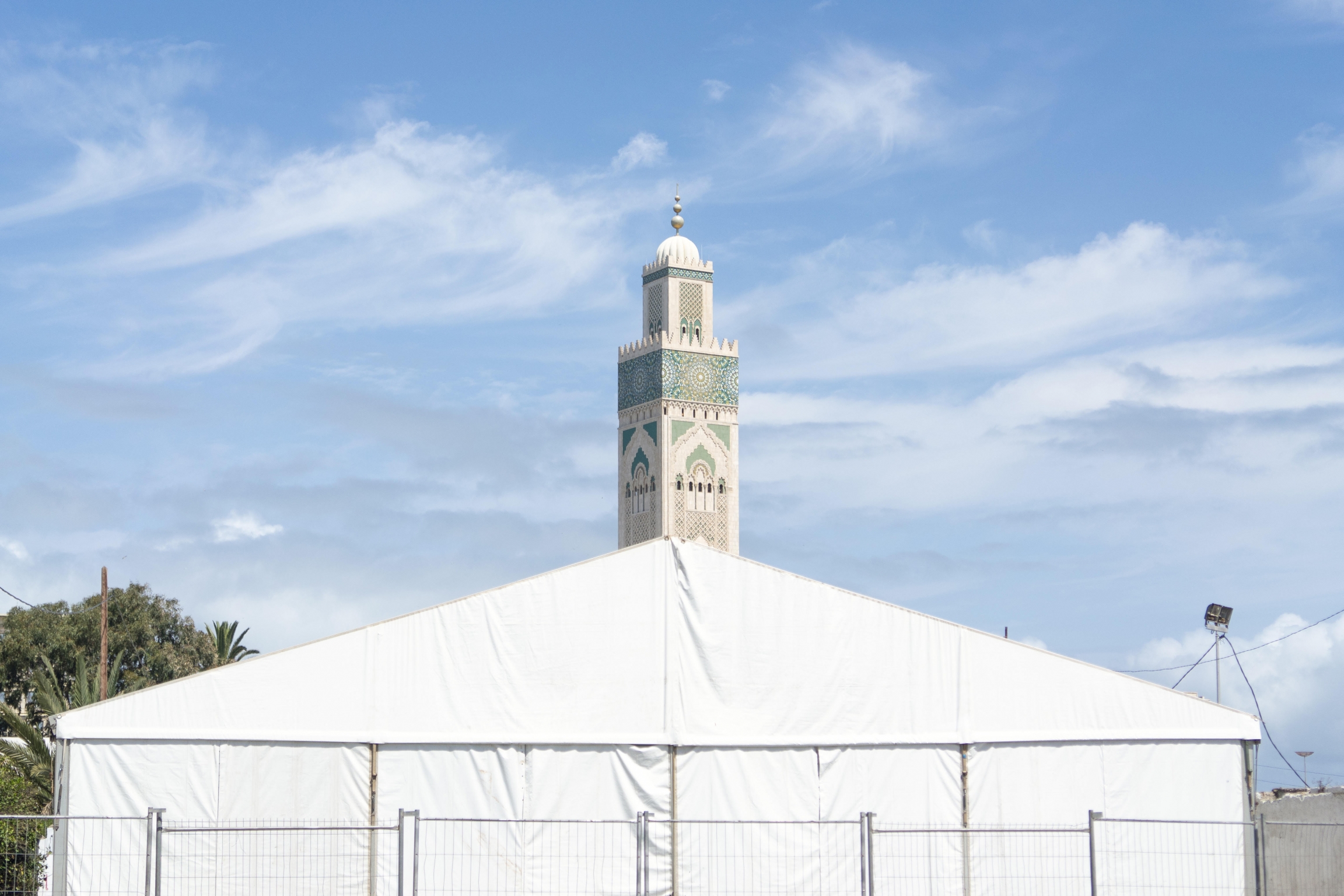 Authorities erected this tent for homeless people needing services during the lockdown. Behind it rises the minaret of the Hassan II mosque, which is now closed. Usually, Hassan II, Africa’s biggest mosque, gets as many as 200,000 worshipers nightly durin Authorities erected this tent for homeless people needing services during the lockdown. Behind it rises the minaret of the Hassan II mosque, which is now closed. Usually, Hassan II, Africa’s biggest mosque, gets as many as 200,000 worshipers nightly durin