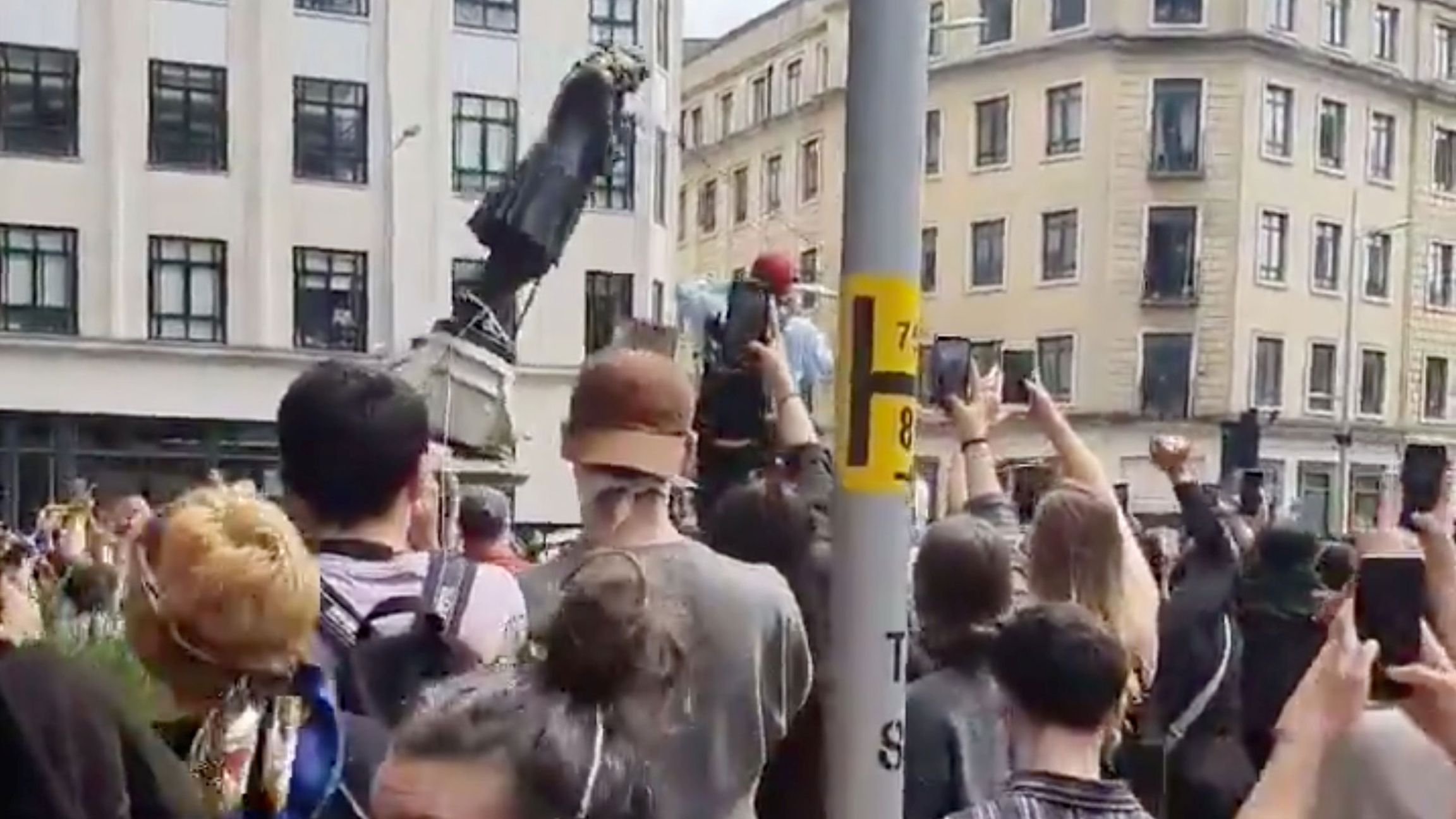 Protesters tear down a statue of Edward Colston during a protest against racial inequality in Bristol, Britain, June 7, 2020 in this screen grab obtained from a social media video. A large group of protesters are shown pulling down the metal statue of Edward Colston.