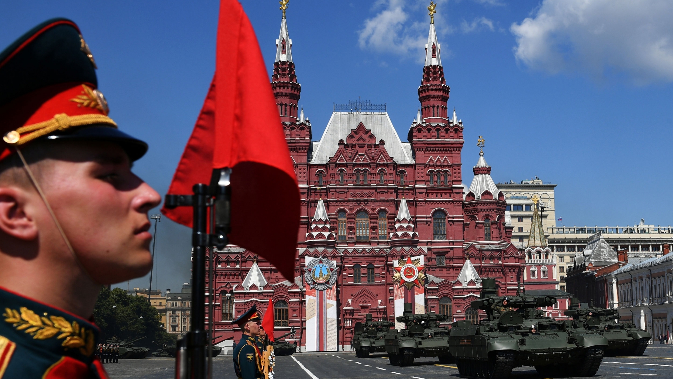 Russian BMPT armored fighting vehicles drive during the Victory Day Parade in Red Square in Moscow, Russia, June 24, 2020. A close up of a man in uniform as tanks drive in Red Square in Moscow