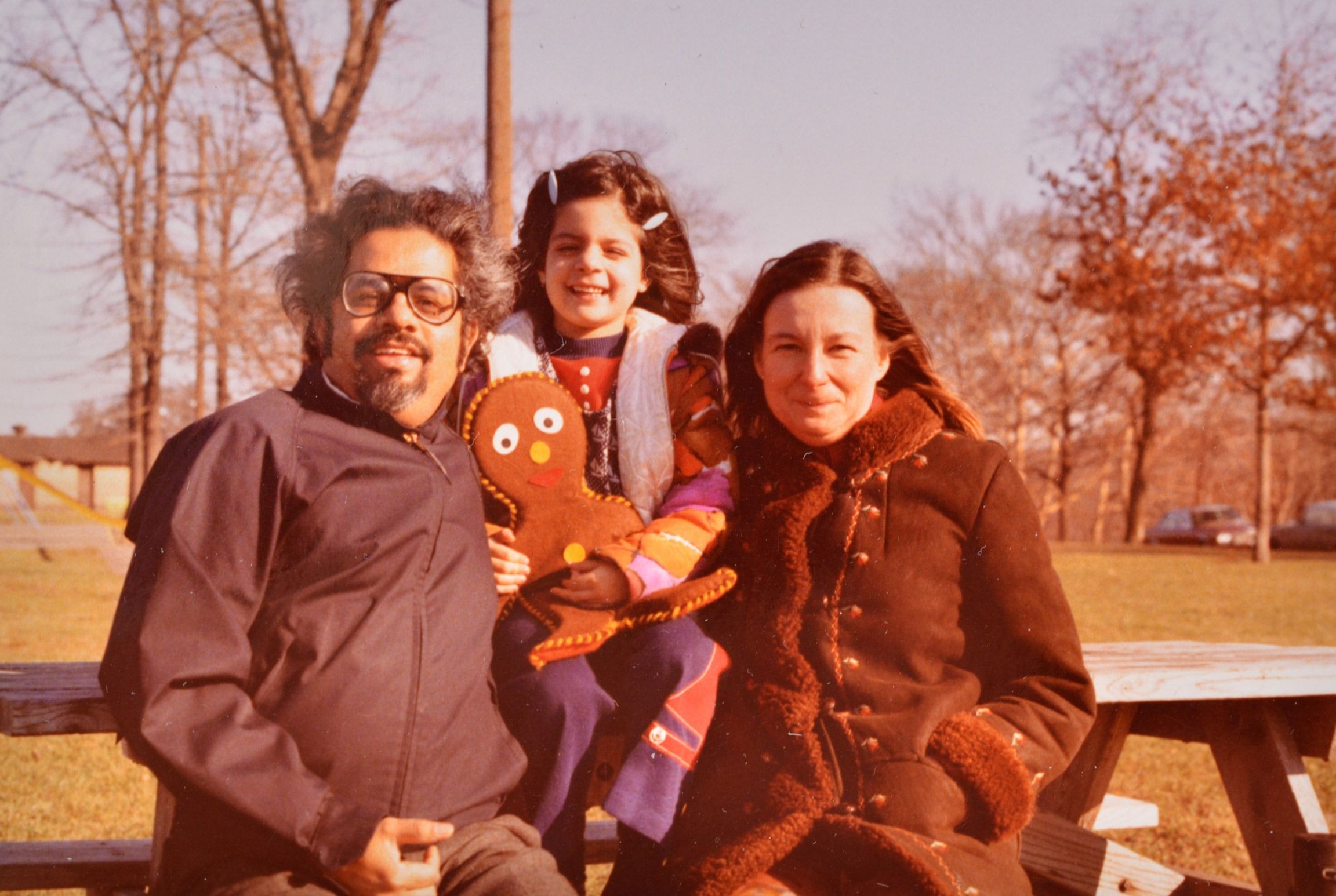Indira Lakshmanan, with her parents, T.R. Lakshmanan (left) and Teresa R. Lakshmanan (right) in 1970s Pittsburgh, Pennsylvania. An older photo of a child between her parents