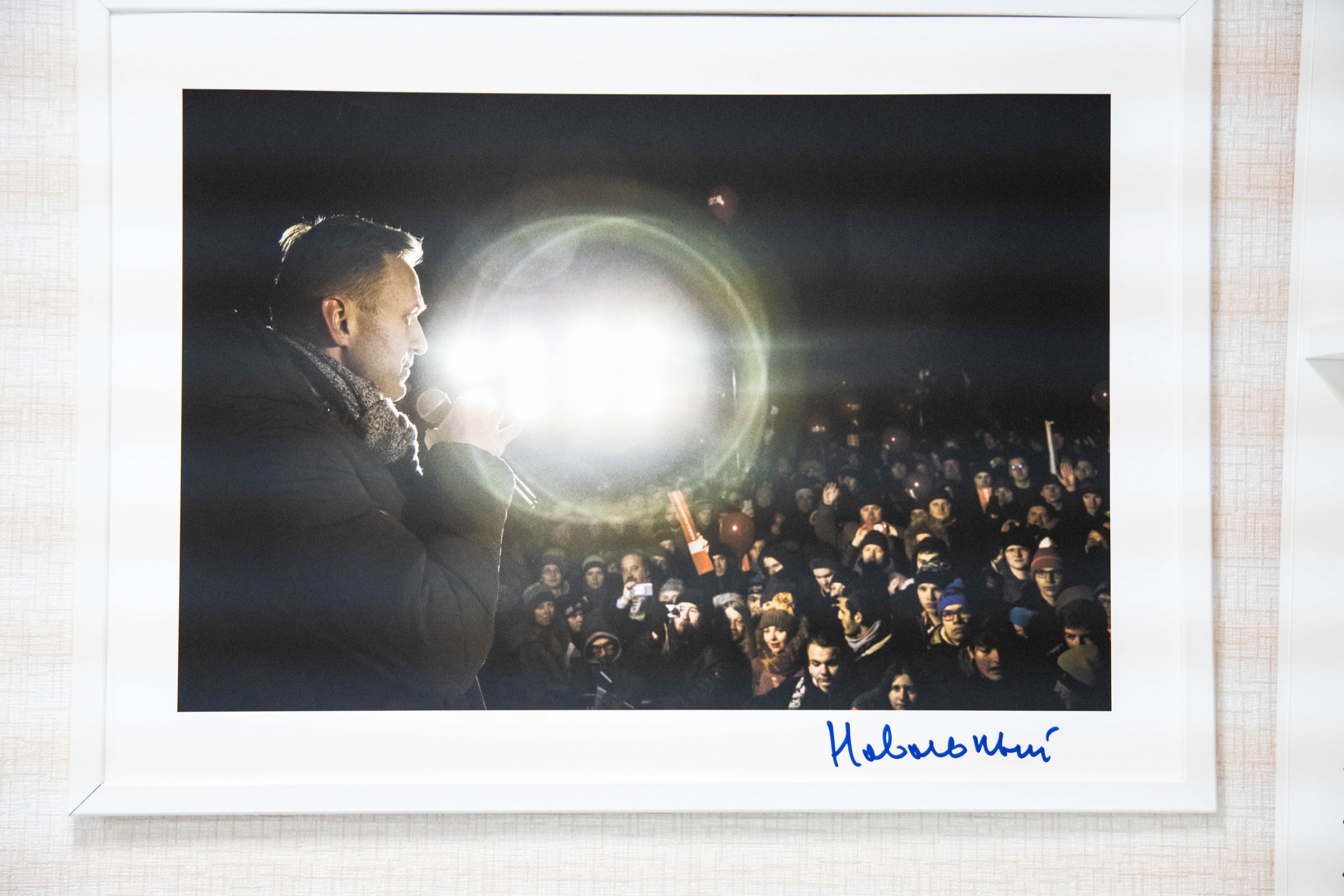 A photo of Alexei Navalny hangs in the Future Russia Party office in Nizhny Novgorod, Russia. A photo hangs on a wall. Someone has written something in blue pen in the border