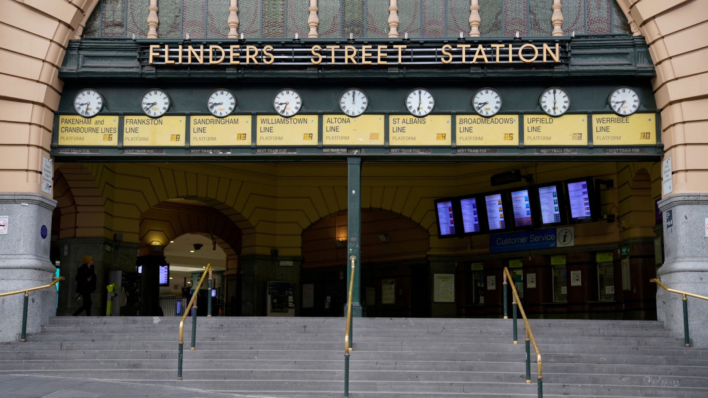 The normally busy Flinders Street train station is seen mostly devoid of people after lockdown restrictions were implemented in response to an outbreak of the coronavirus in Melbourne, Australia, July 10, 2020. The entrance to Flinders Street train station is shown with nine clocks along the top and nearly empty of people.