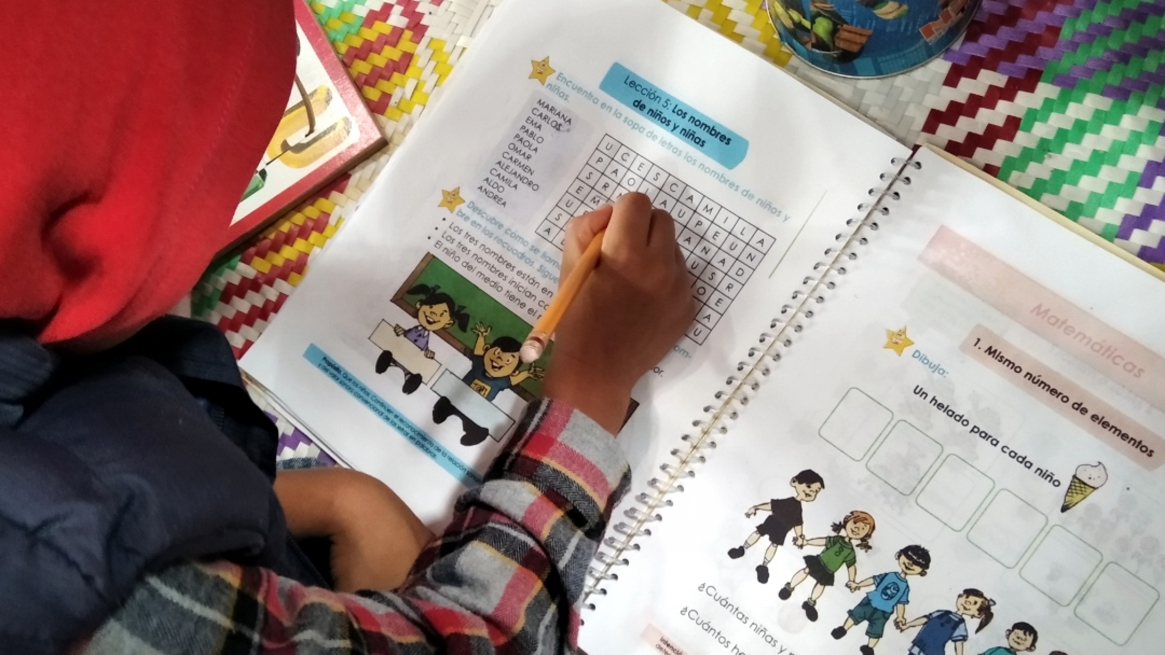 As millions of students in Mexico head back to school with lessons broadcast on TV, some teachers in Oaxaca are bypassing TV school altogether with weekly booklets of worksheets. A student hovers over a notebook and fills in a lesson.