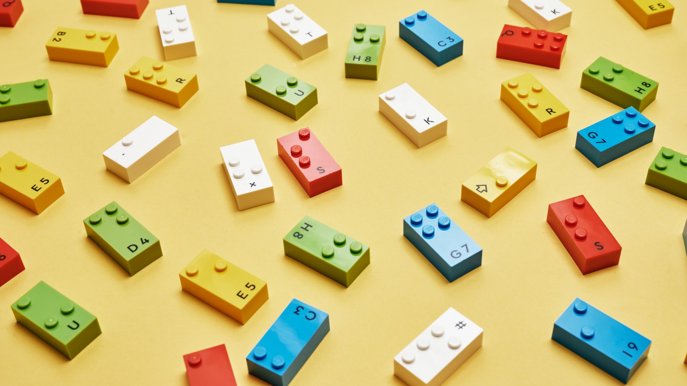 Each kit will contain 300+ Lego Braille Bricks covering the full alphabet in the chosen language, numbers 0-9, and select mathematical symbols and punctuation marks. Braille Bricks are seen on the floor.