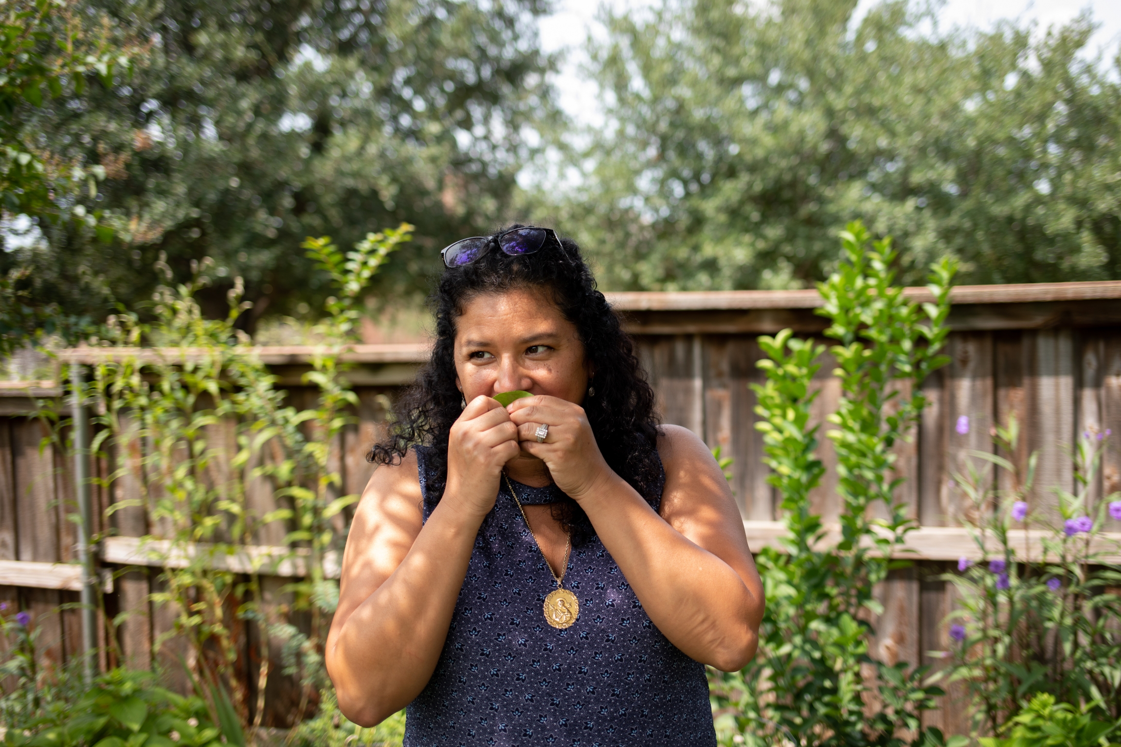 Xochitl Ortiz smells a leaf from a tree in the family backyard in Fort Worth, Texas. Xochitl Ortiz smells a leaf from a tree in the family backyard in Fort Worth, Texas.
