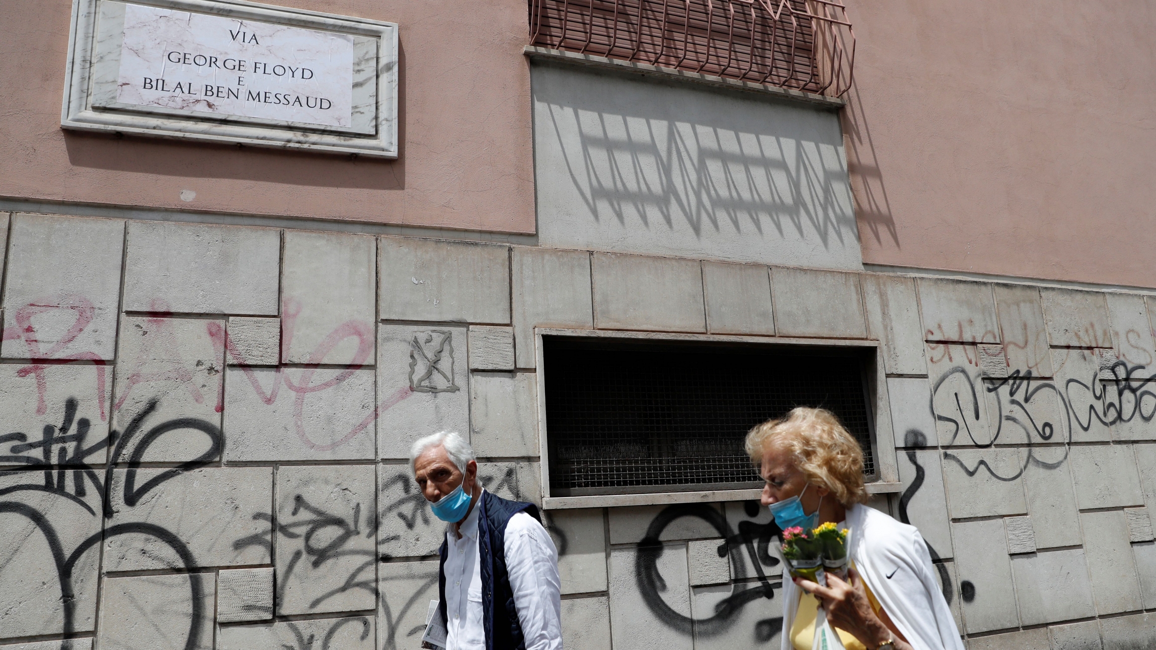 People walk near the former street sign for ''Via dell'Amba Aradam'' People walk near the former street sign for ''Via dell'Amba Aradam''