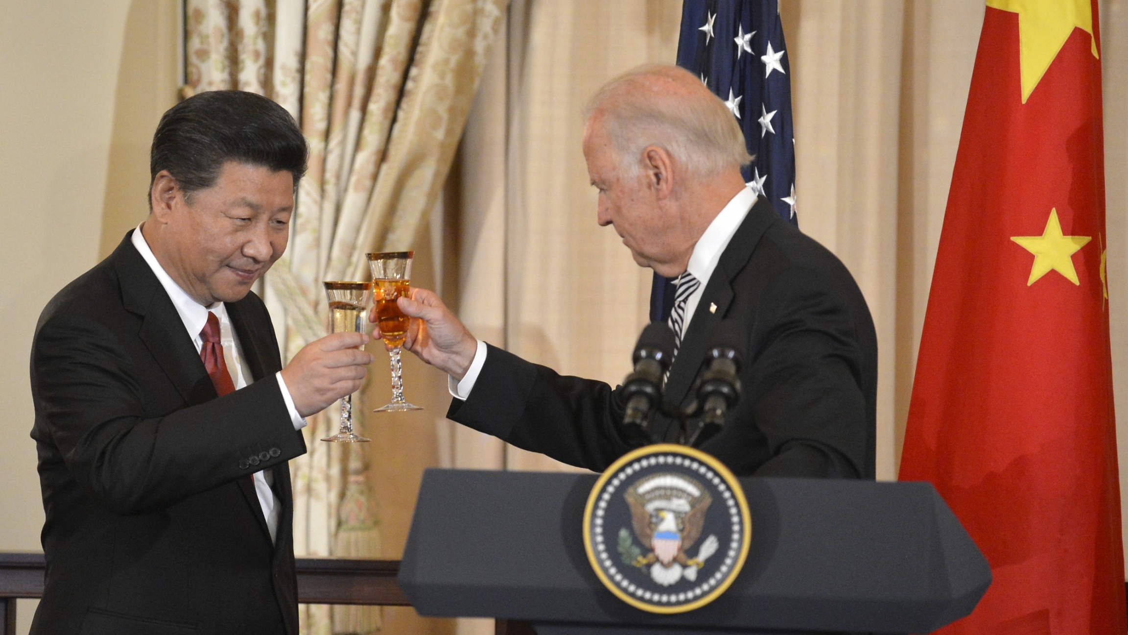 Chinese President Xi Jinping and then-Vice President Joe Biden raise their glasses in a toast during a luncheon at the State Department, in Washington, Sept. 25, 2015.