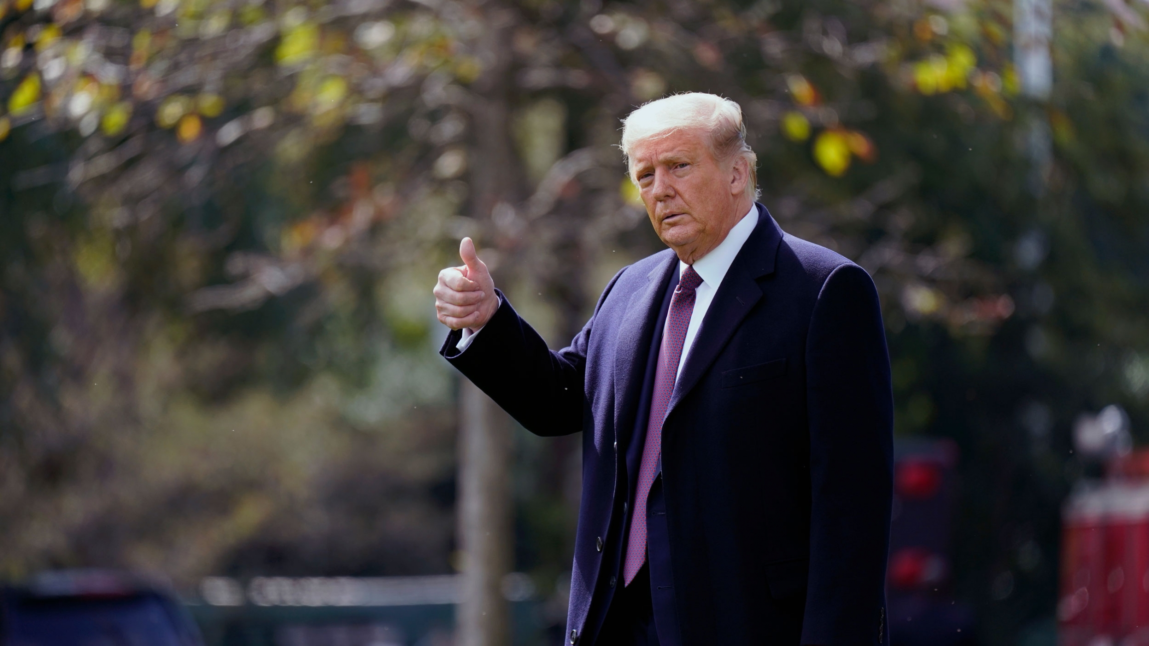 President Donald Trump gives a thumbs-up as he walks to Marine One from the White House in Washington, Thursday, Oct. 1, 2020. President Donald Trump is shown wearing an overcoat and purple tie and giving the thumbs-up sign.