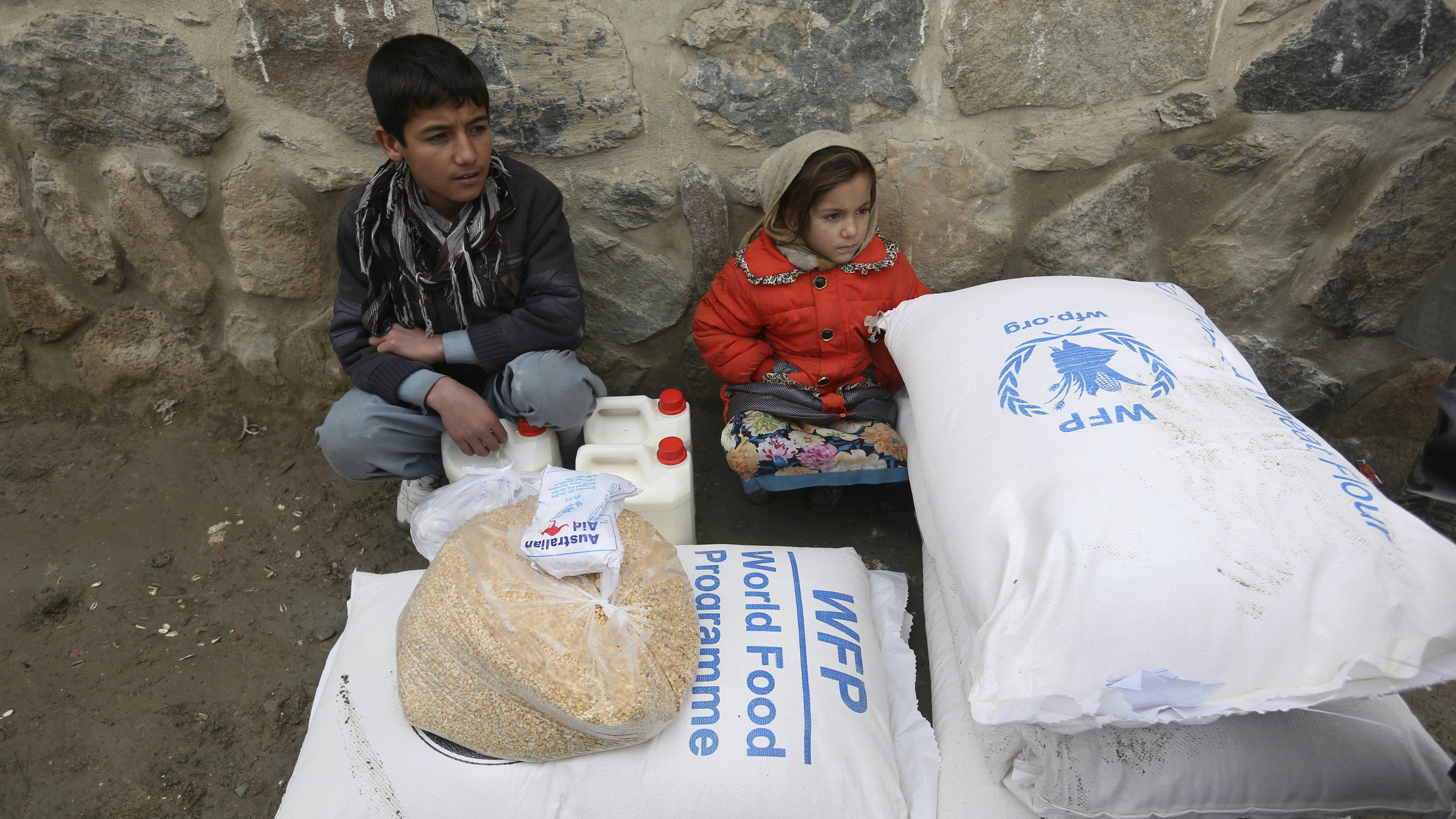 In this Jan. 24, 2017 file photo, children wait for transportation after receiving food donated by the World Food Program, in Kabul, Afghanistan. In this Jan. 24, 2017 file photo, children wait for transportation after receiving food donated by the World Food Program, in Kabul, Afghanistan.