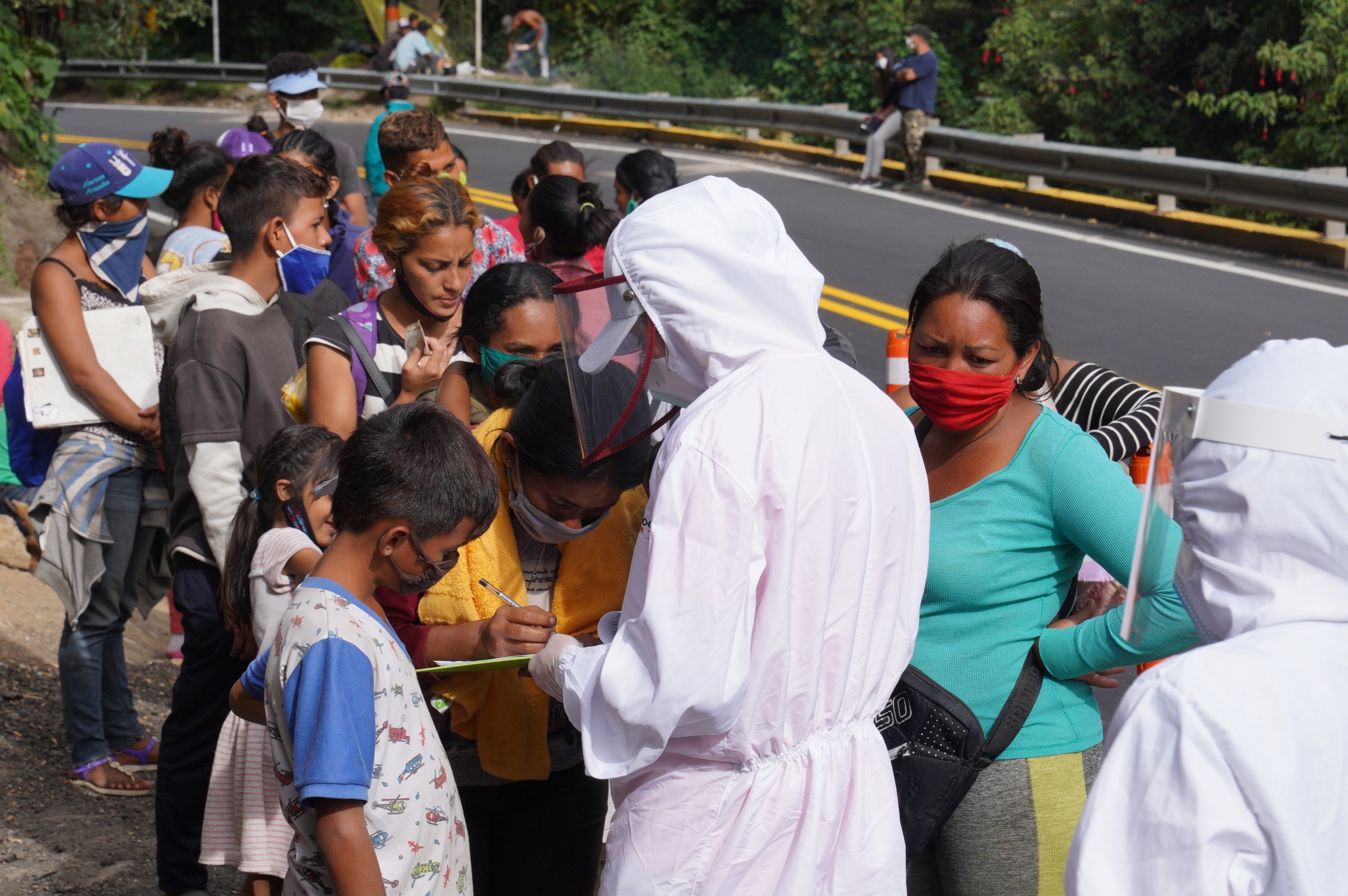 A humanitarian worker registers Venezuelan migrants arriving in Pamplona, Colombia, on Sept. 30. Social workers say that 200 migrants are passing through the country each day. A humanitarian worker registers Venezuelan migrants arriving in Pamplona, Colombia, on Sept. 30. Social workers say that 200 migrants are passing through the country each day.