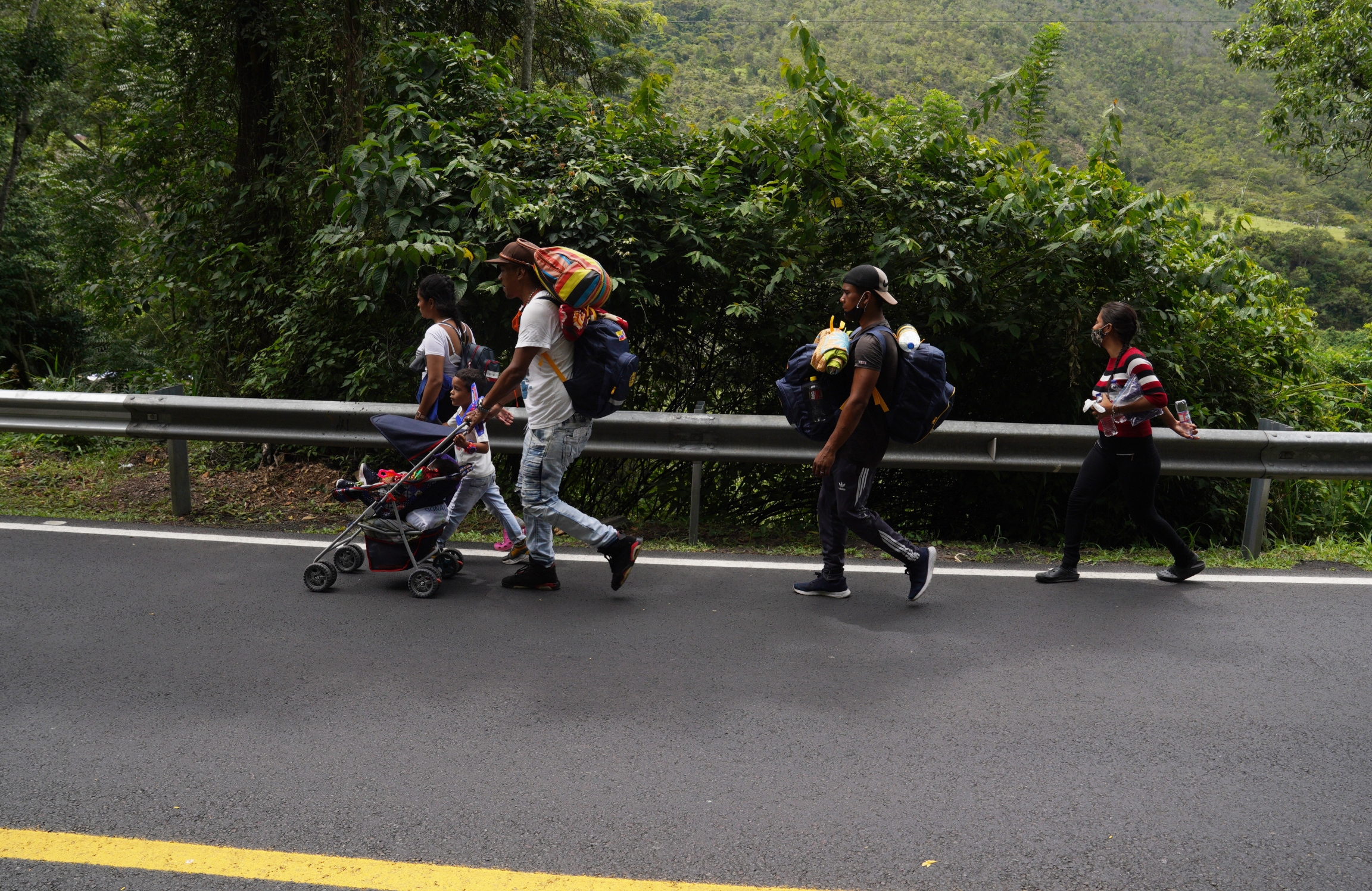 A family from Caracas, Venezuela walks along the road leading to Pamplona, Colombia, on Sept. 30. This family was heading to Ecuador where they had been promised work on a farm. A family from Caracas, Venezuela walks along the road leading to Pamplona, Colombia, on Sept. 30. This family was heading to Ecuador where they had been promised work on a farm.