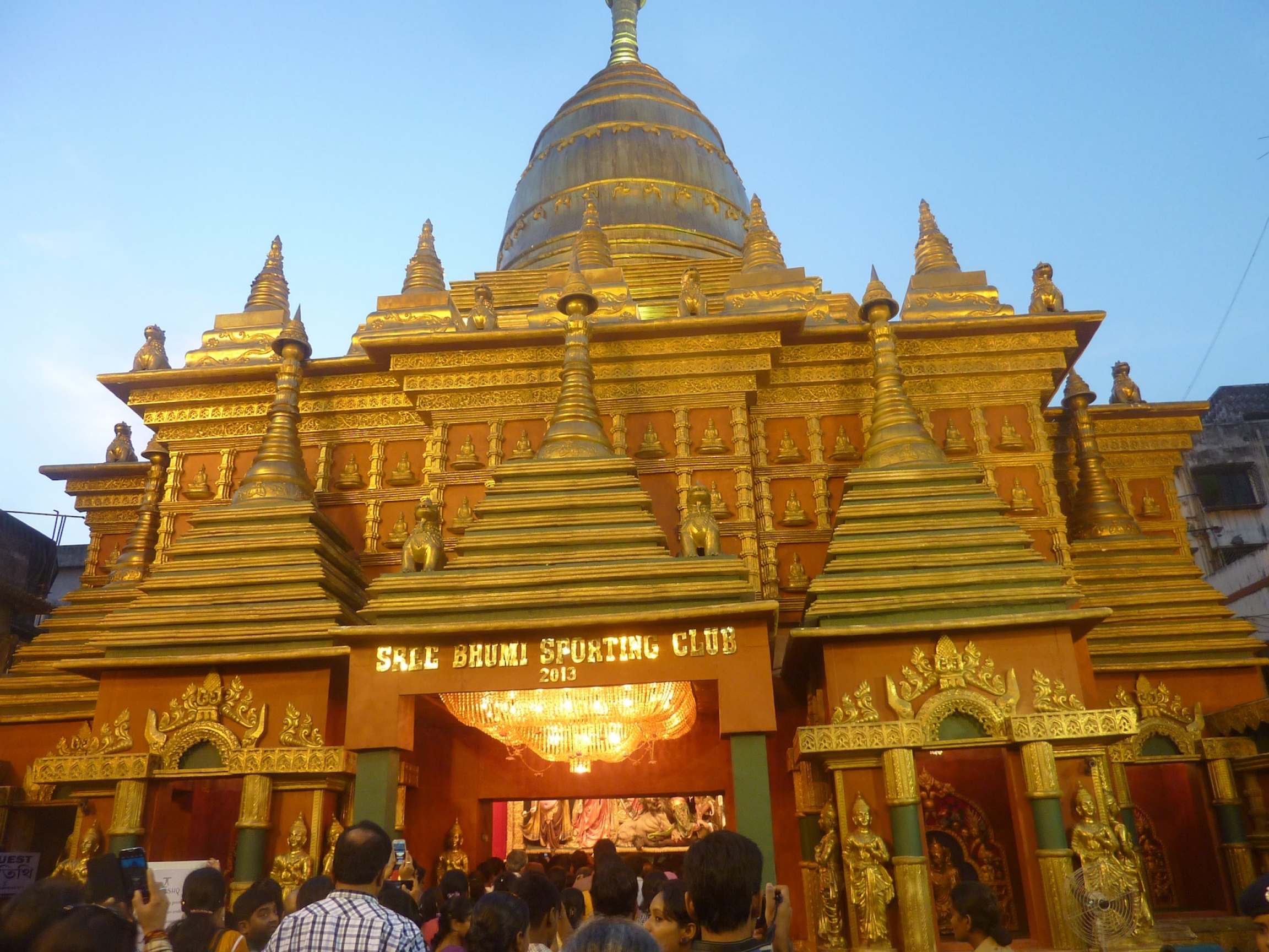 Durga Puja pandal in the shape of a Thai temple, Kolkata, India, 2017. An ornate structure with golden tipped points in the shape of a Thai-style temple.
