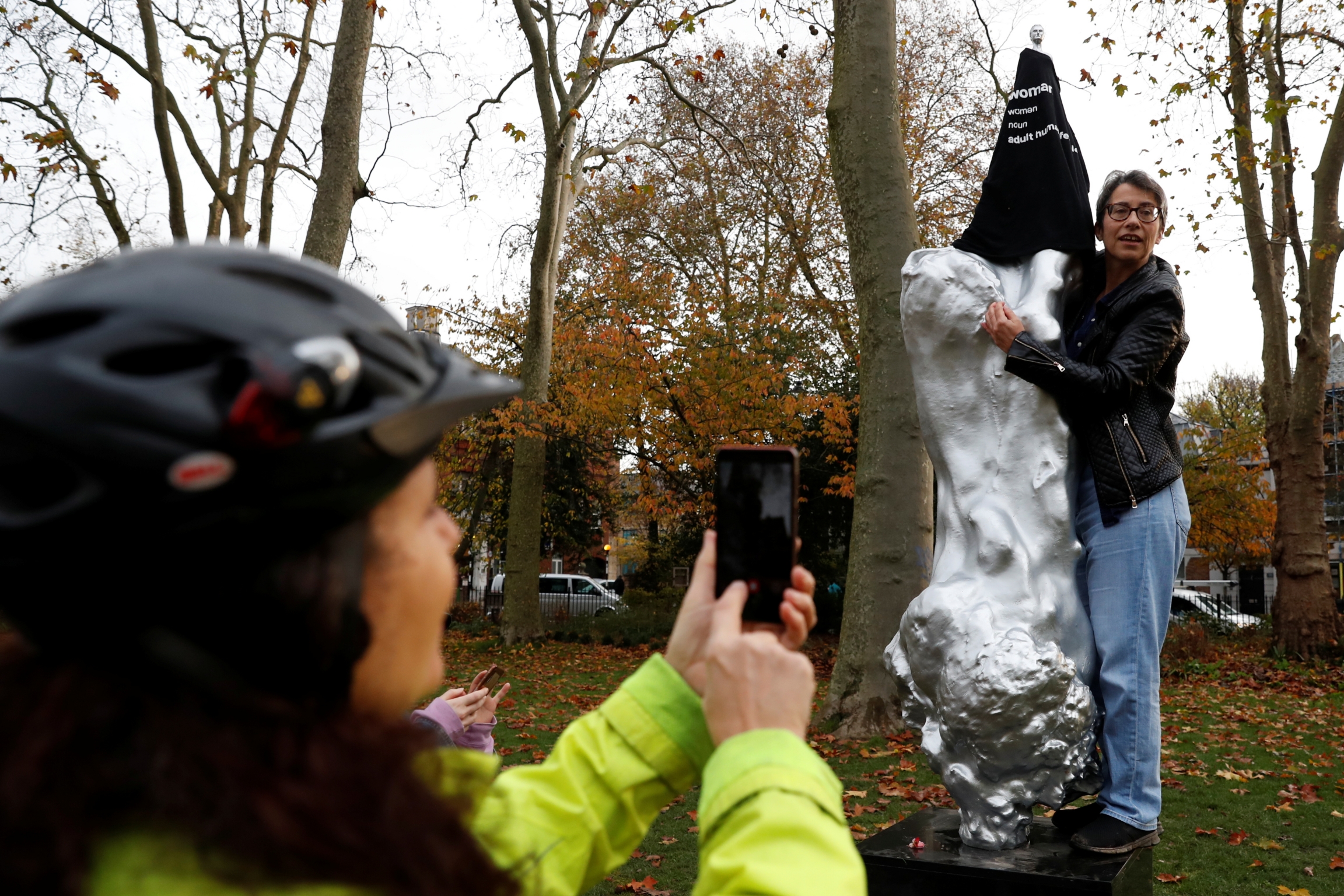 A protester covers with a T-shirt the Mary Wollstonecraft statue by artist Maggi Hambling, in Newington Green, London, Britain, Nov. 11, 2020. A protester covers with a T-shirt the Mary Wollstonecraft statue by artist Maggi Hambling, in Newington Green, London, Britain, Nov. 11, 2020.