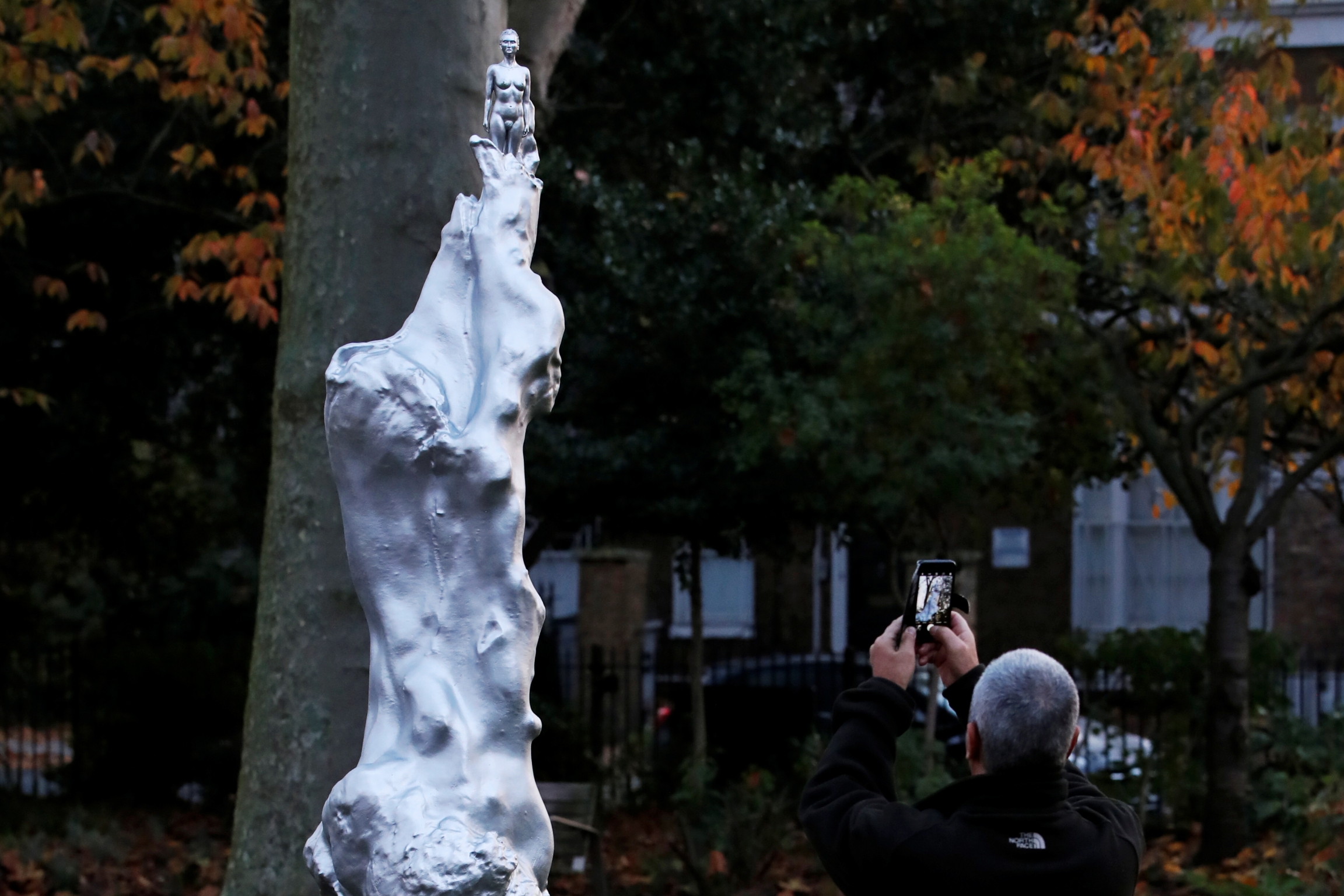 A person takes a photo of the Mary Wollstonecraft statue by artist Maggi Hambling in Newington Green, London, Britain, Nov. 11, 2020. A person takes a photo of the Mary Wollstonecraft statue by artist Maggi Hambling in Newington Green, London, Britain, Nov. 11, 2020.