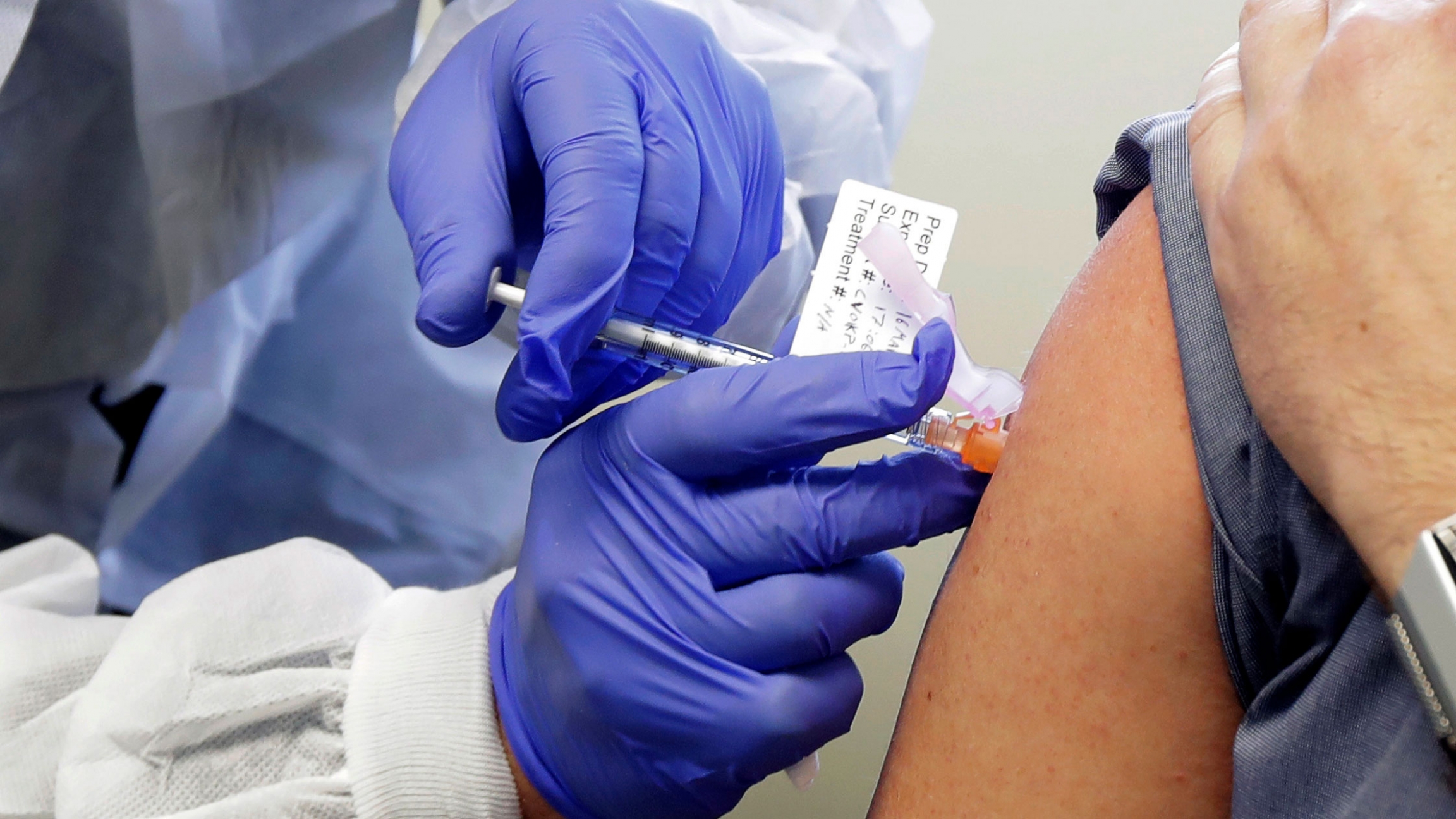 Neal Browning receives a shot in the first-stage safety study of a potential vaccine for COVID-19 at the Kaiser Permanente Washington Health Research Institute in Seattle. Moderna said Monday, Nov. 16, its coronavirus vaccine is proving to be highly effec A close up photograph of an arm being injected with a syringe.