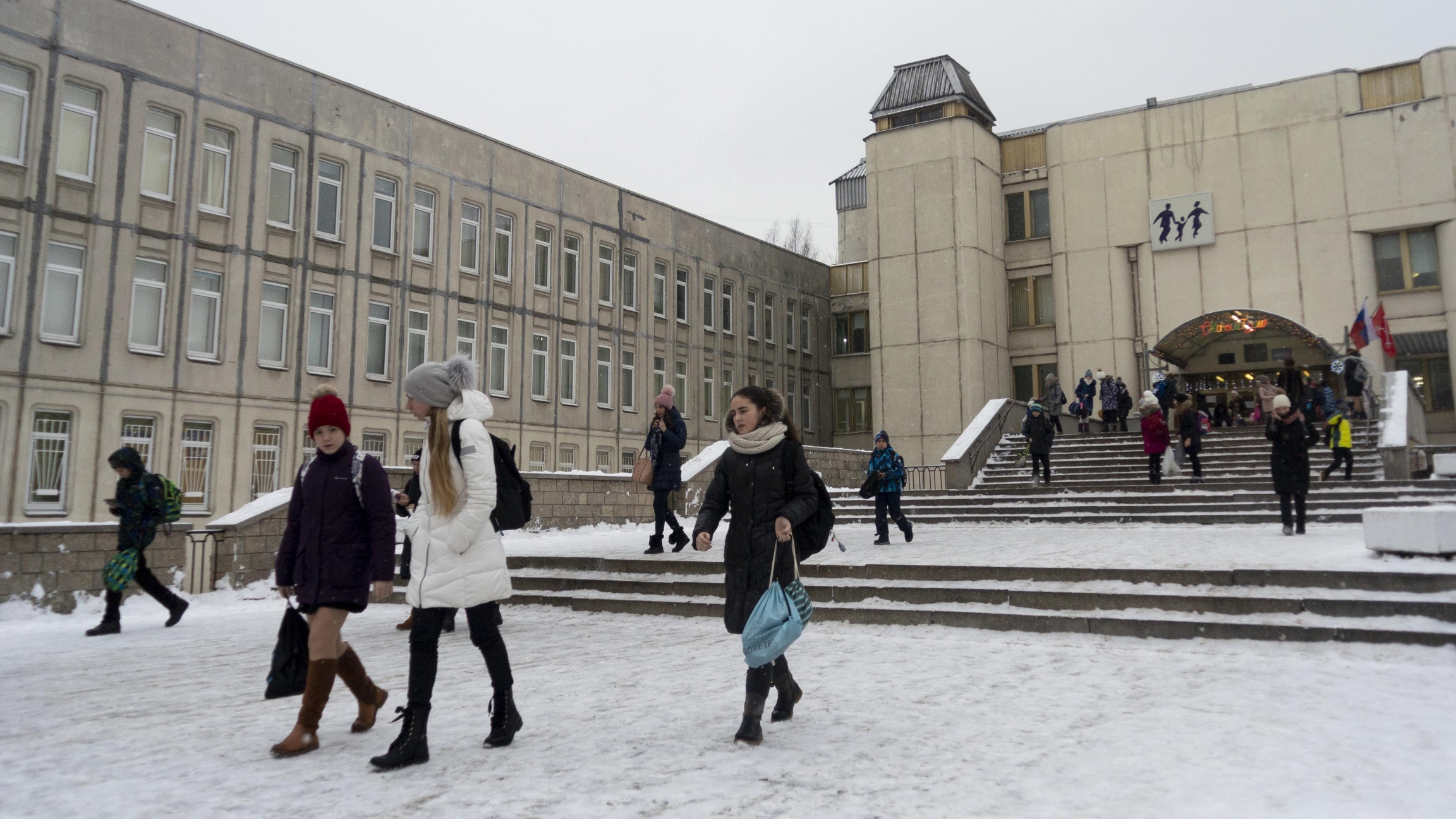 In this photo taken on Thursday, Dec. 20, 2018, students come out of a school building in St. Petersburg, Russia.