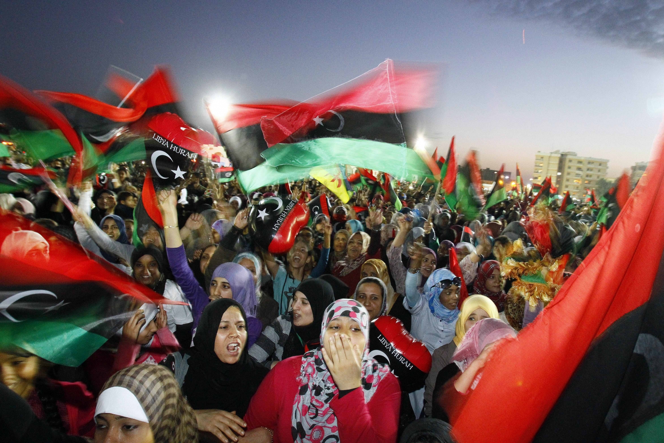 In this Sunday Oct. 23, 2011 file photo, Libyan celebrate at Saha Kish Square in Benghazi, Libya, as Libya's transitional government declares the official liberation of Libya after months of bloodshed that culminated in the death of longtime leader Moamma