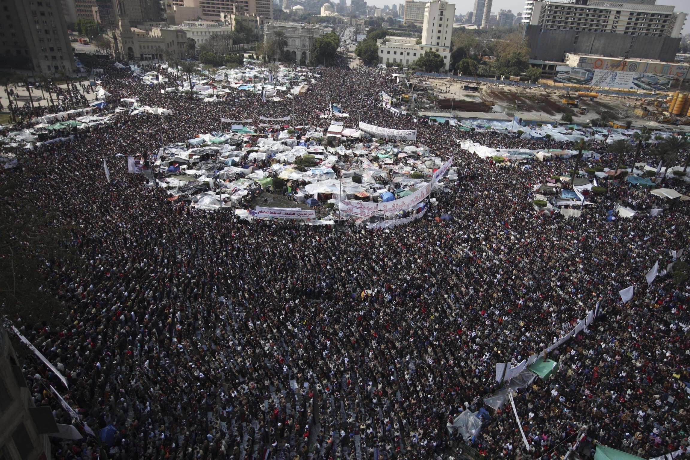 In this Feb. 11, 2011 file photo, anti-government protesters perform Friday prayers at the continuing demonstration in Tahrir Square, Cairo, Egypt.