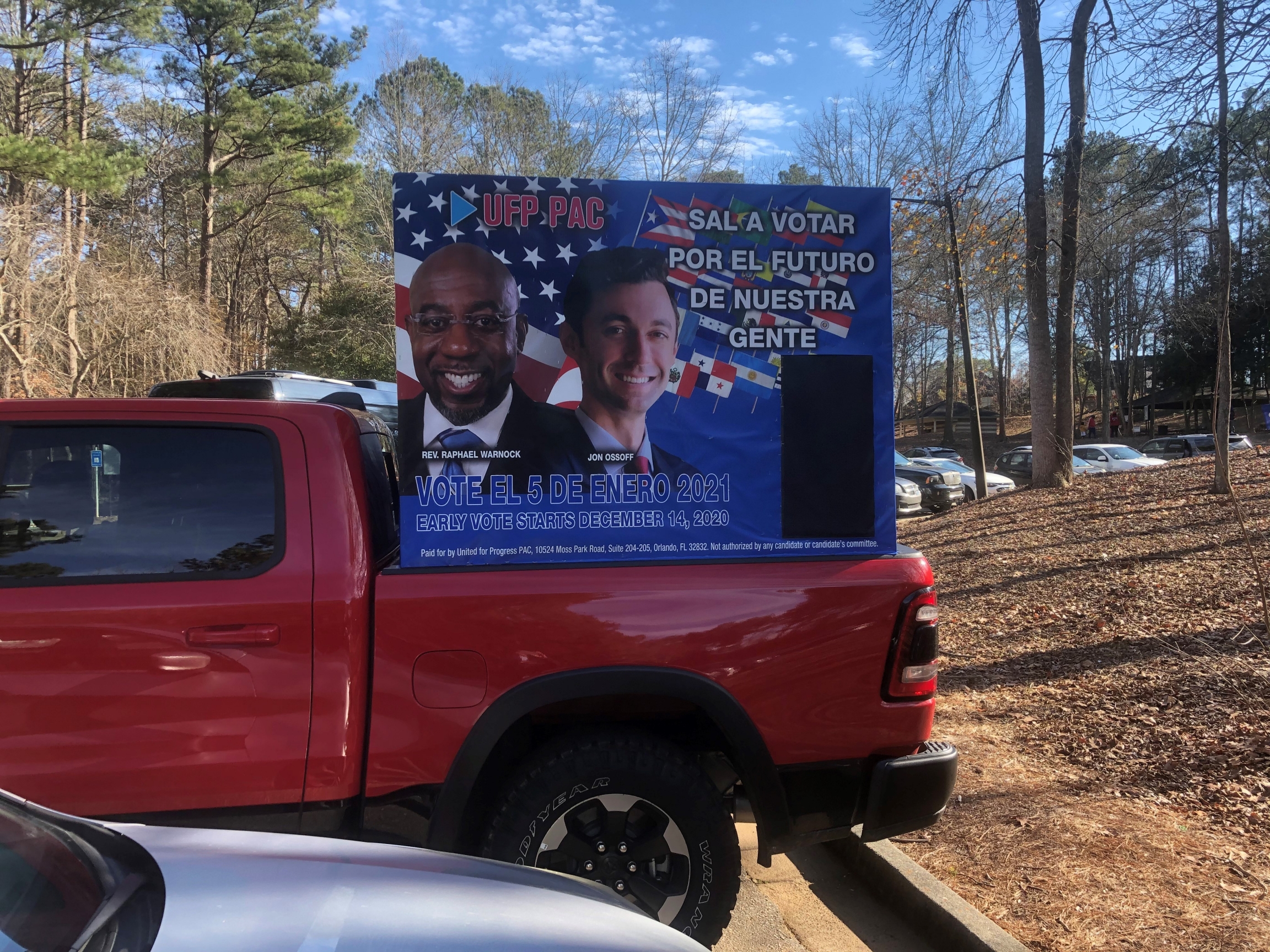 A red campaign truck features candidates Rev. Raphael Warnock and Jon Ossoff. A red campaign truck features candidates Rev. Raphael Warnock and Jon Ossoff.