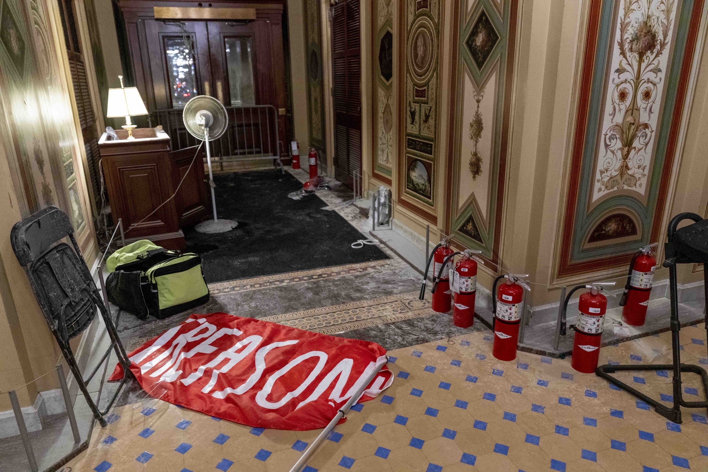 A flag that reads "Treason" is visible on the ground in the early morning hours of Thursday, Jan. 7, 2021, after a violent mob loyal to President Donald Trump stormed the US Capitol in Washington DC. A flag that reads "Treason" is visible on the ground of the US Capitol building.