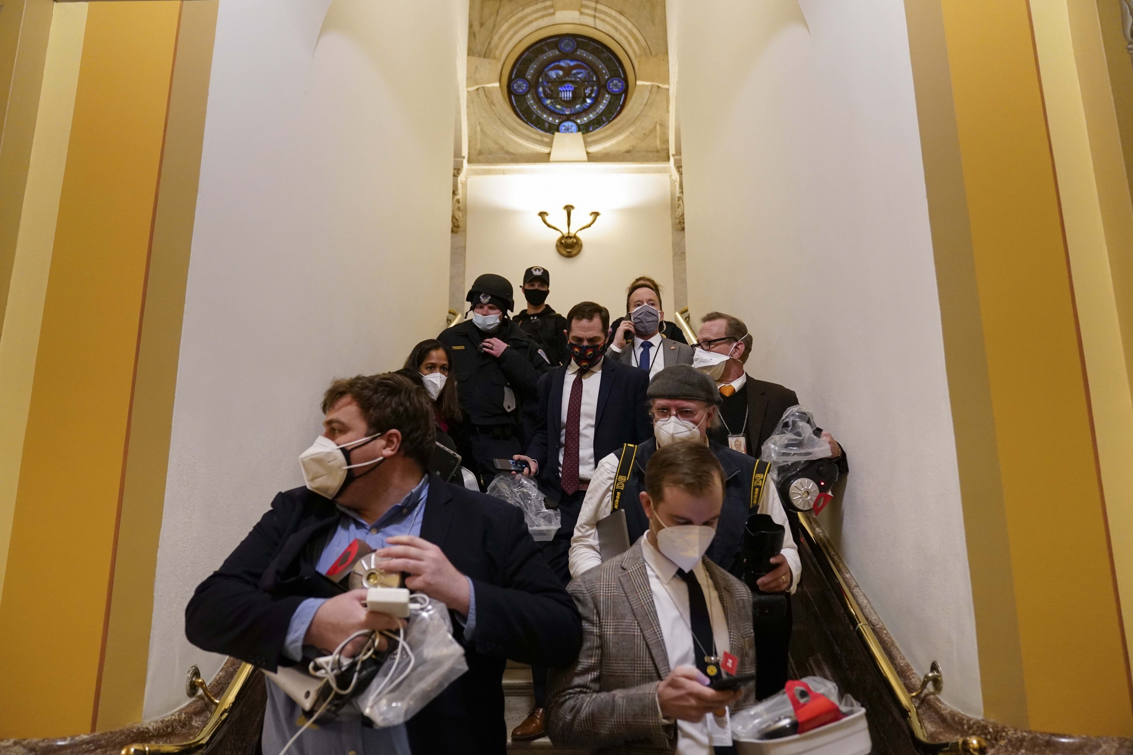 People evacuate from the House chamber as a violent mob of Trump supporters try to break in at the US Capitol on Wednesday, Jan. 6, 2021, in Washington, DC. People evacuate from the House chamber as a violent mob of Trump supporters try to break in at the US Capitol on Wednesday, Jan. 6, 2021, in Washington, DC.