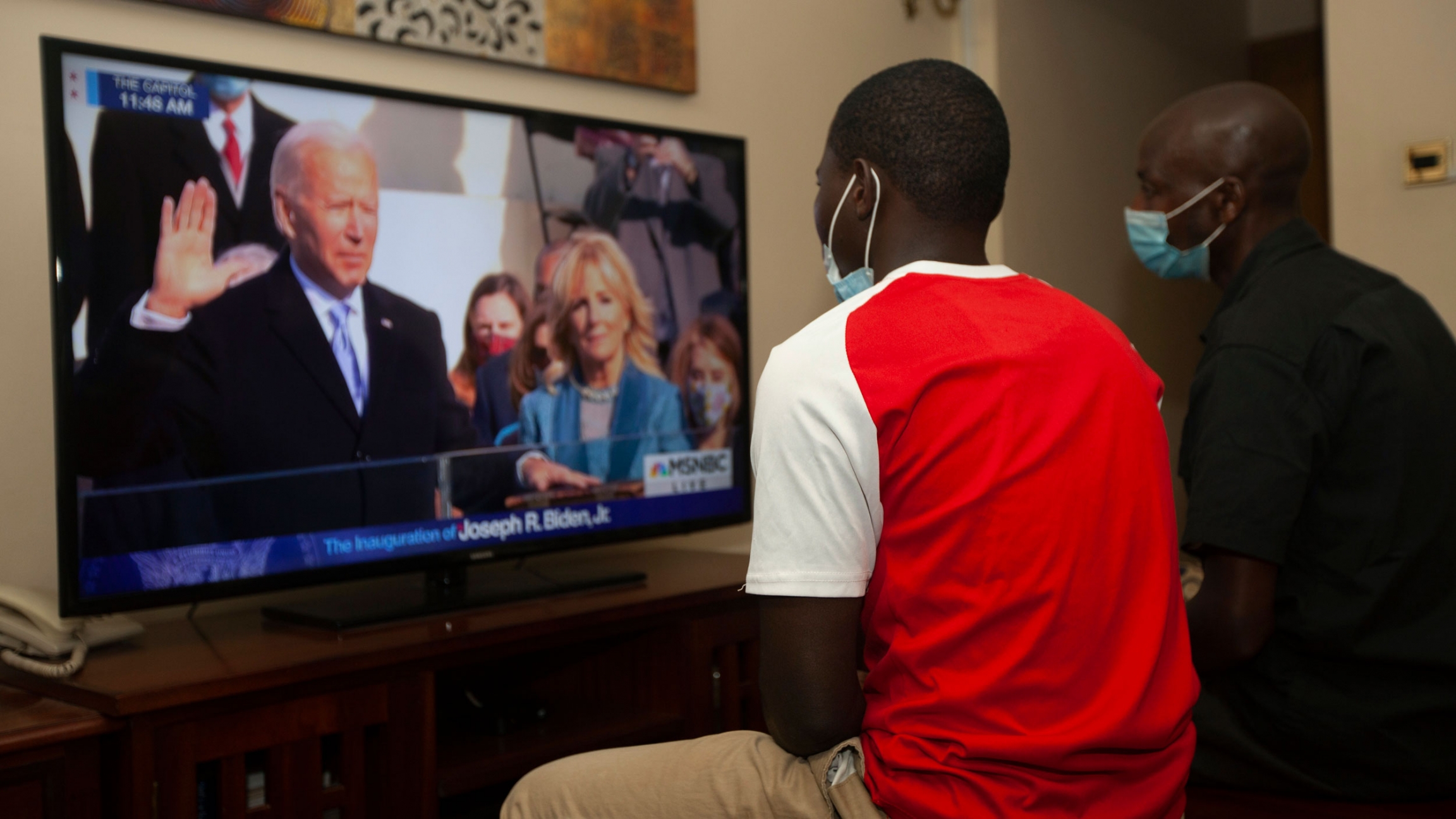 Kenyans watch President-elect Joe Biden's inauguration on TV, in Nairobi. Biden has officially become the 46th president of the United States, Jan. 20, 2021. Two Kenyan men are shown sitting and watching President-elect Joe Biden's inauguration on TV.
