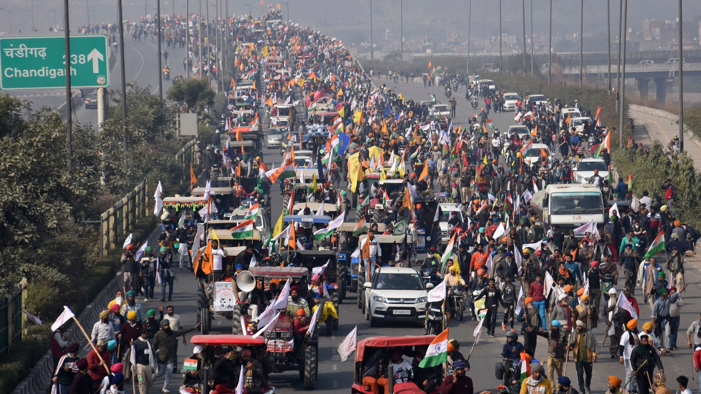 Farmers participate in a protest march toward the capital during India's Republic Day celebrations in New Delhi, India, Jan. 26, 2021. A multiple lane road is shown filled with protesters driving tractors and other vehicles with thousands of people shown all over the road.