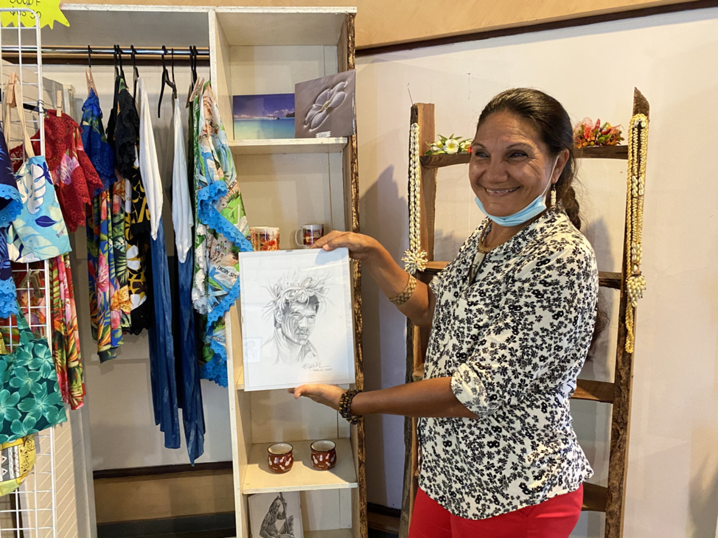 Patricia Marchand is the owner of Eriki Arts, a small boutique on the southern part of the island of Tahiti. A woman stands in a boutique featuring her items for sale.