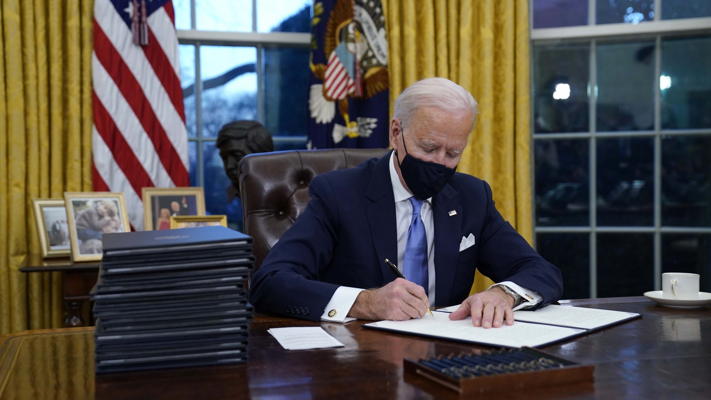 President Joe Biden signs his first executive order in the Oval Office of the White House on Jan. 20, 2021, in Washington, DC. President Joe Biden signs his first executive order in the Oval Office of the White House on Jan. 20, 2021, in Washington, DC.