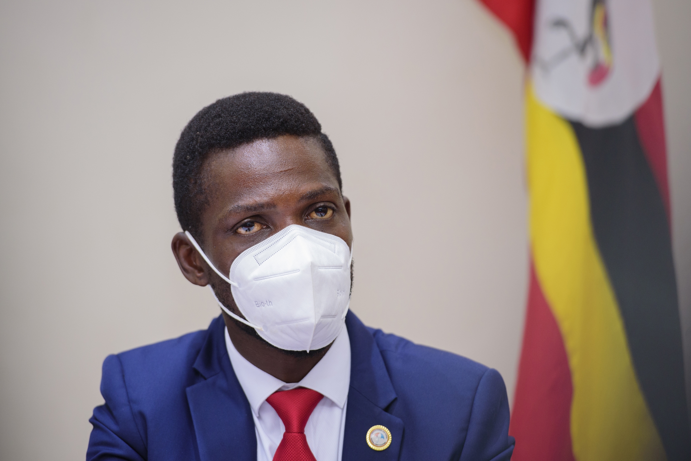 Ugandan presidential candidate, Bobi Wine, during a press conference in Kampala, Uganda, Tuesday, Jan.12, 2021. Bobi Wine, during a press conference in Kampala Uganda, Tuesday, Jan.12, 2021, wears a white face mask and blue suit with red tie.