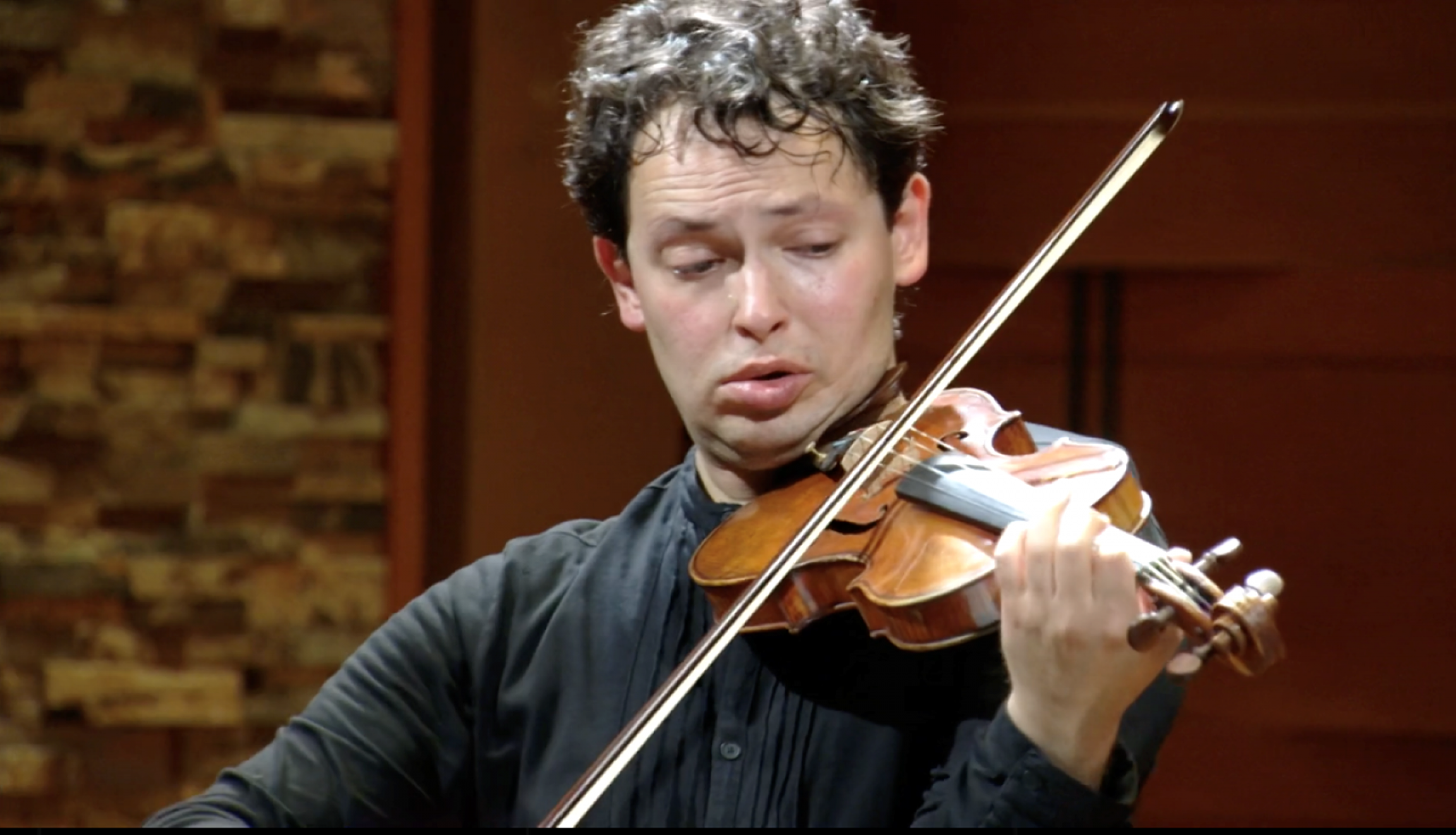 Yevgeny Kutik is a professional violinist. A man holds a violin