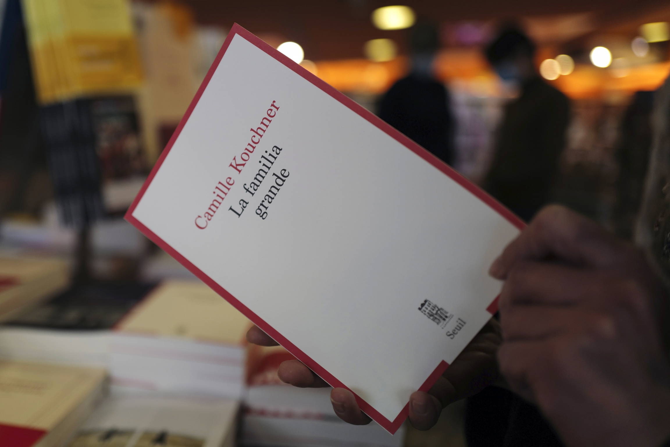 A person holds the book "La Familia Grande," by Camille Kouchner, in a bookstore of Paris, Wednesday, Jan. 20, 2021. A person holds a book in their hands