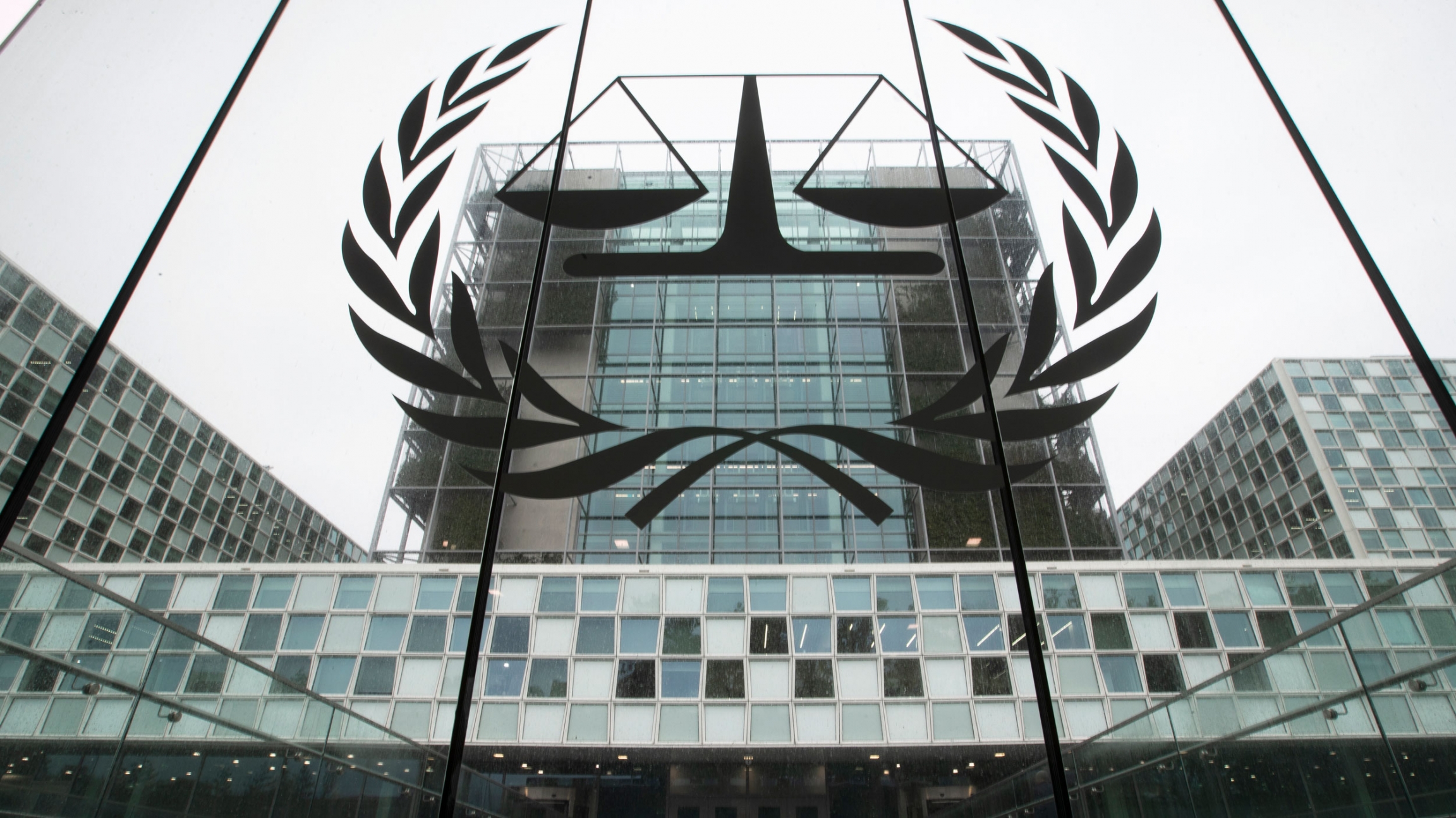 The International Criminal Court is seen in The Hague, Netherlands. The mosaic glass facade of the International Criminal Court is seen in a photograph from street level looking up.