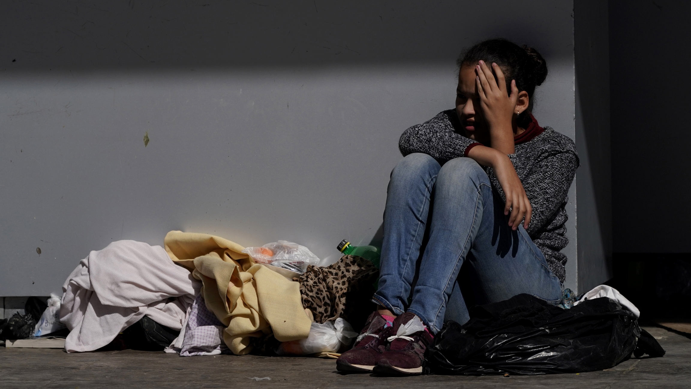 A migrant shields herself from the sun A migrant shields herself from the sun