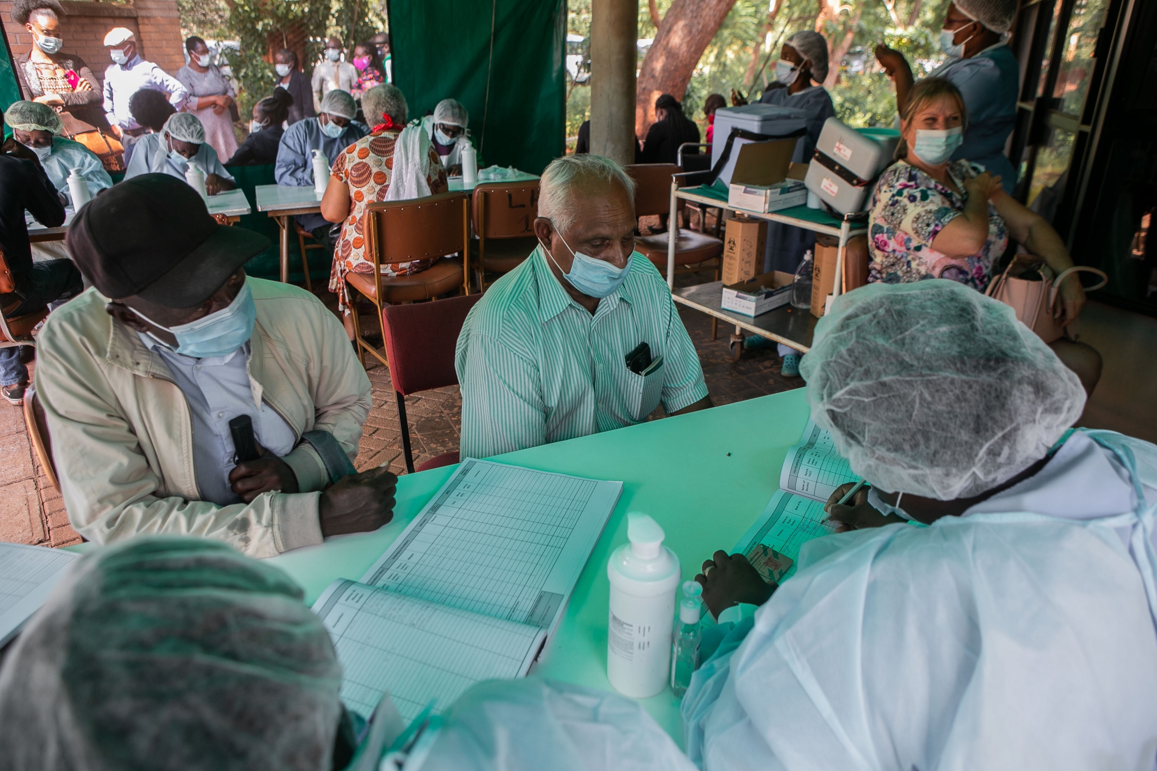 Since the Zimbabwe government opened vaccination to all who want one, there has been an increase in traffic at the country vaccination centers, March 31, 2021, Harare, Zimbabwe. Citizens receive vaccinations with PPE-wearing health workers