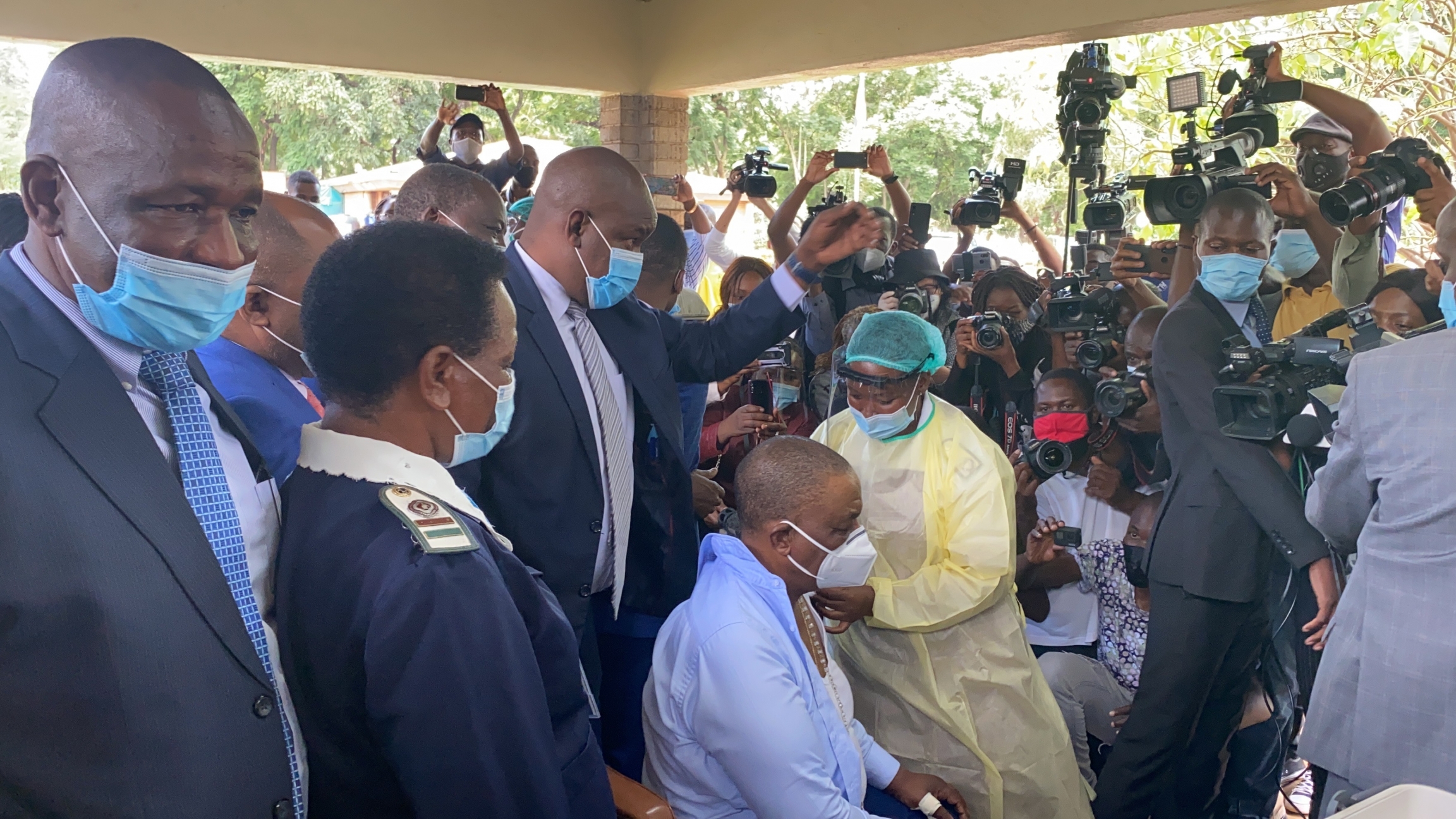 Zimbabwe Vice President Constantino Chiwenga (seated, wearing a blue shirt) gets his Sinopharm vaccine at country's main vaccination center, Wilkins Hospital, on March 31, 2021, in Harare, Zimbabwe. A public official receives a vaccination in public display