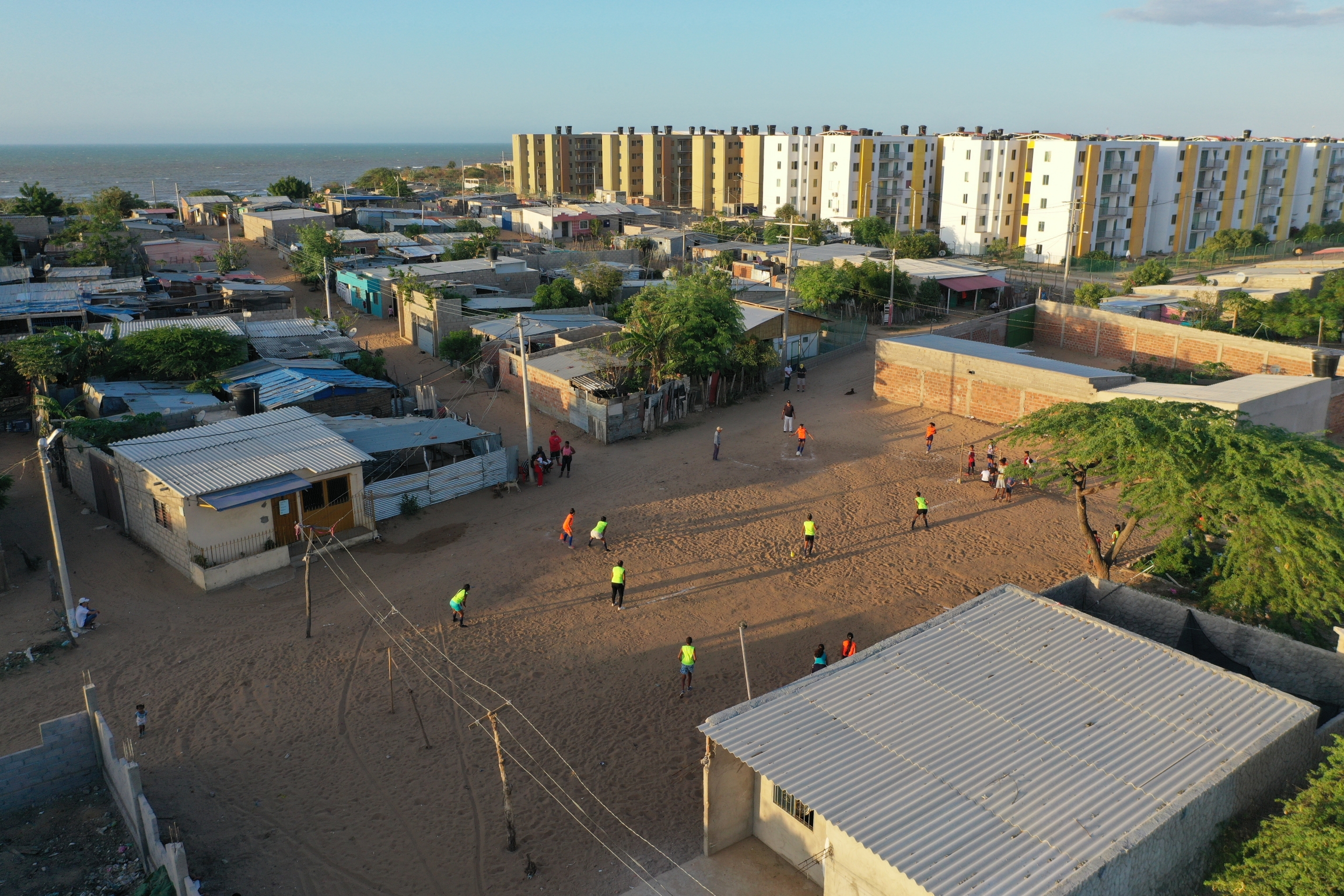 Children play kickball in a dusty field during practice in the Brisas del Norte neighborhood of Riohacha, Colombia. Children play kickball in a dusty field during practice in the Brisas del Norte neighborhood of Riohacha, Colombia.